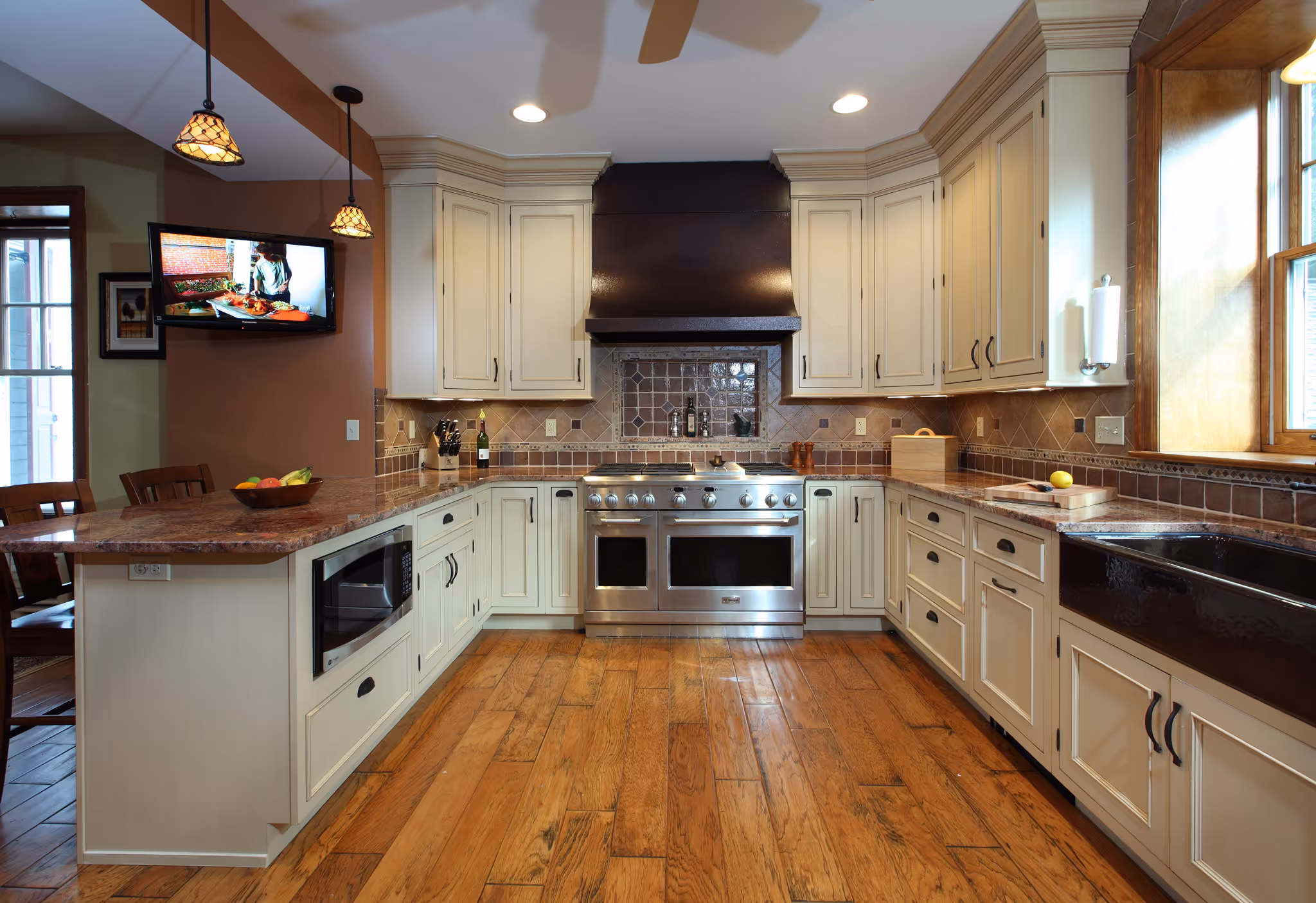 Stylish kitchen with granite countertops, modern appliances, and wooden flooring in harrisburg, pa