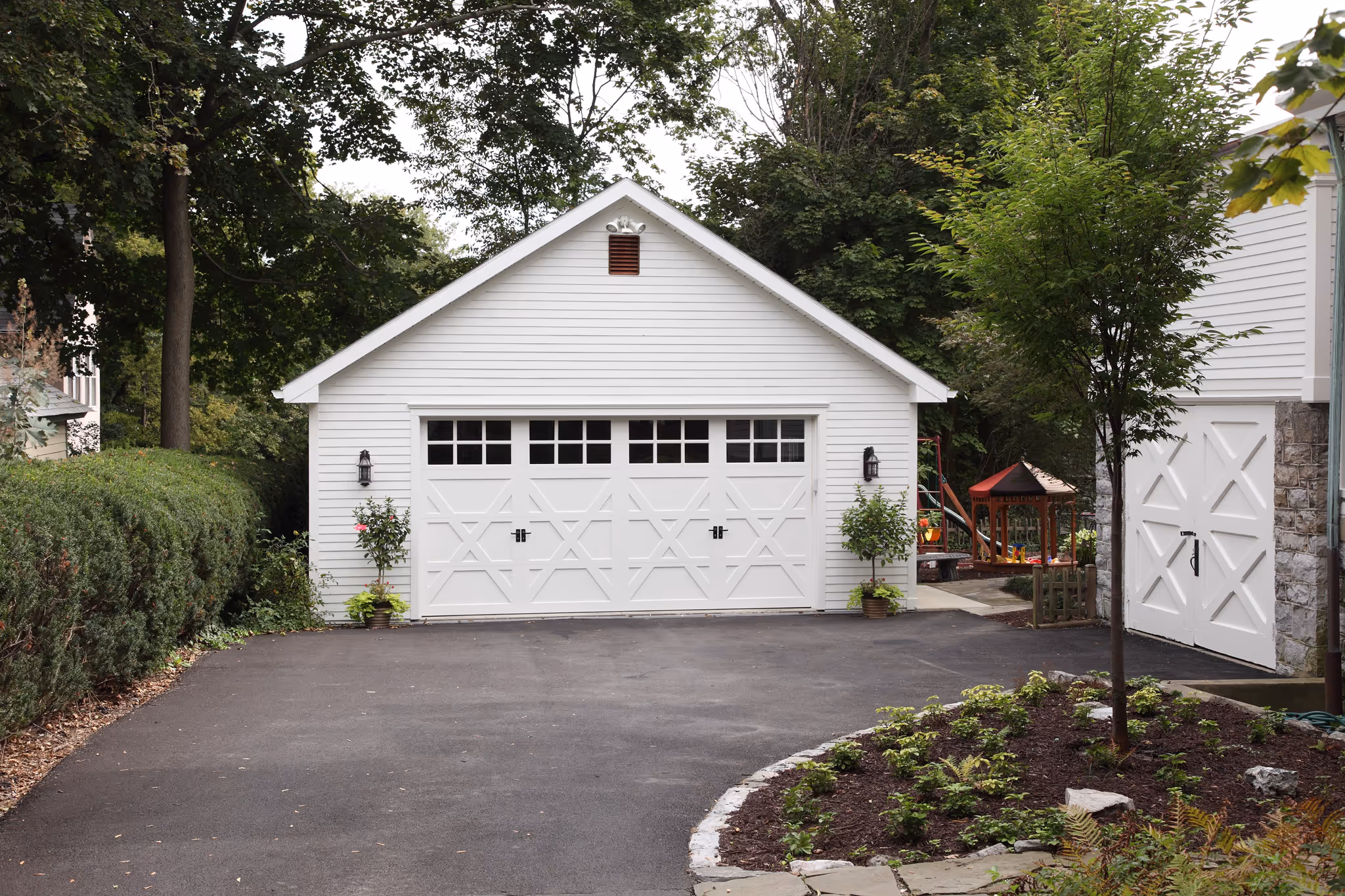 Charming white modern garage with landscaped surroundings in Harrisburg, PA.