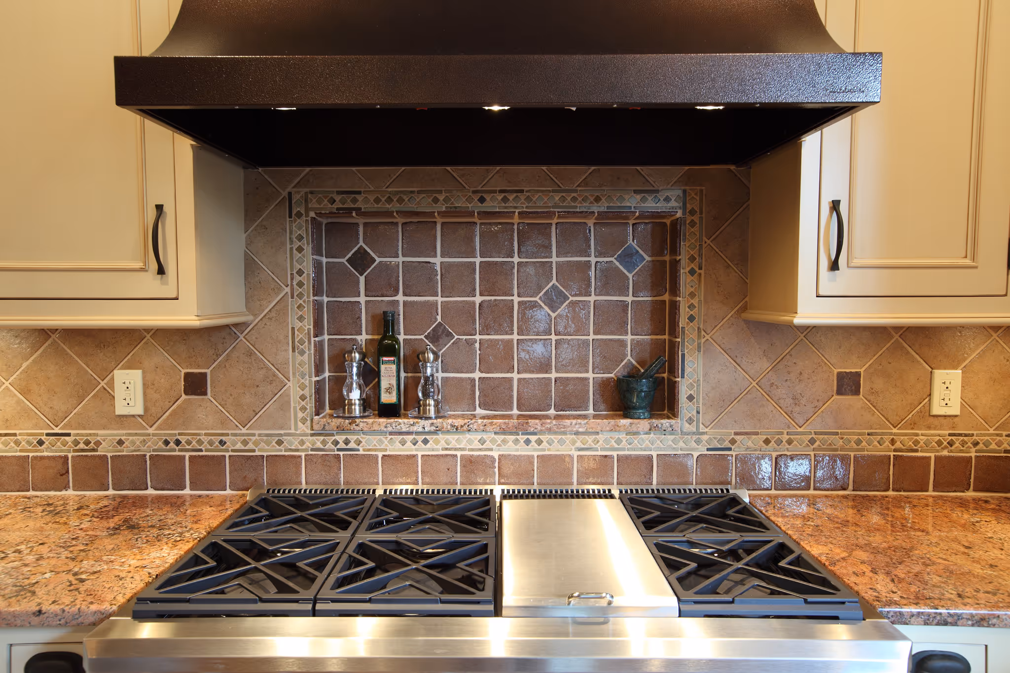 Luxurious kitchen in Harrisburg, PA with a granite countertop, elegant tile backsplash, and stainless-steel appliances.