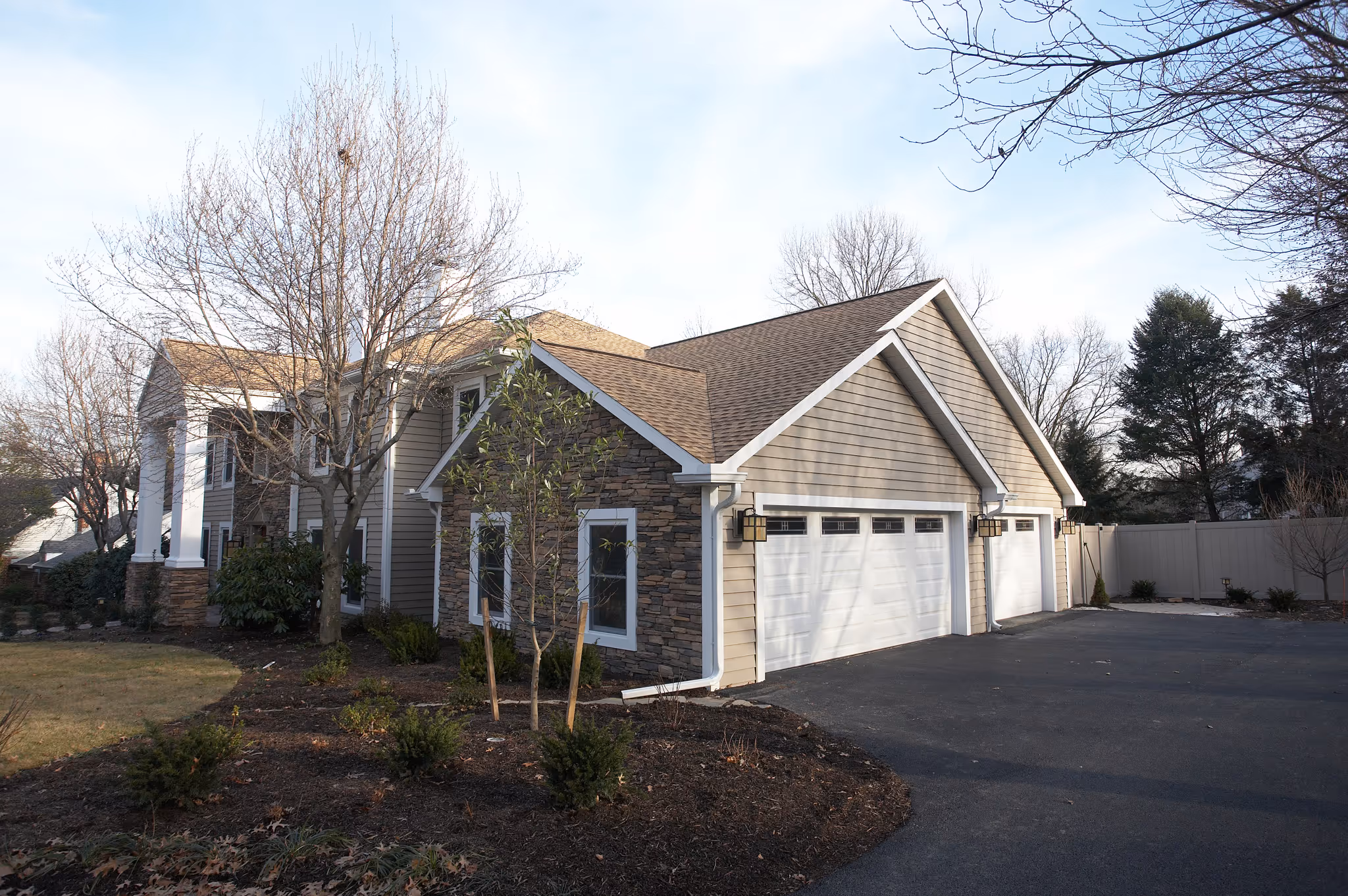 Contemporary exterior of a house featuring stone accents and a well-maintained landscape in camp hill, pa