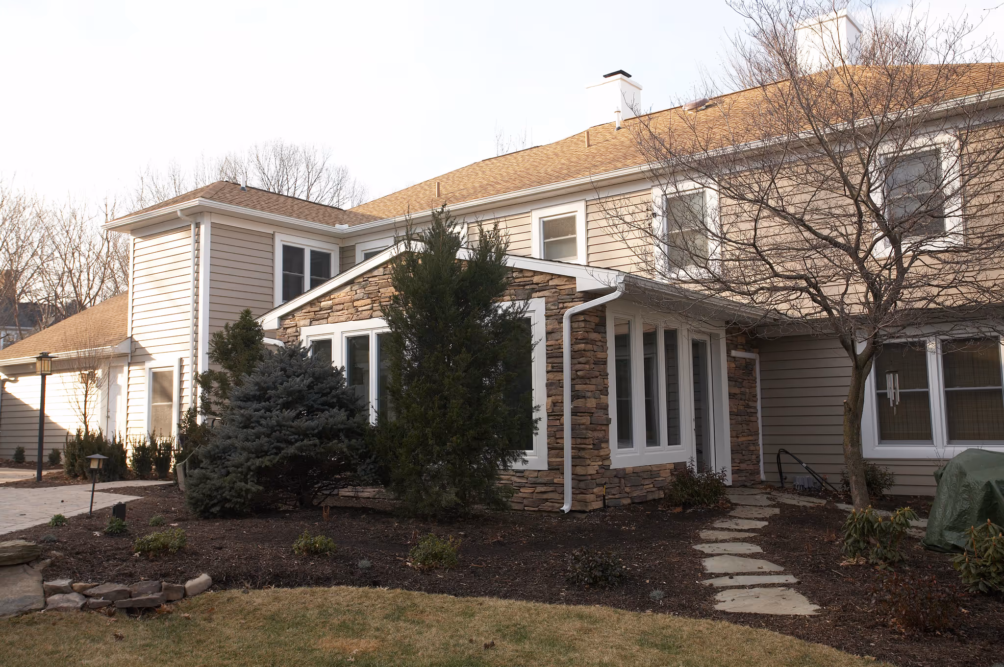 Charming exterior view of a modern home with stone accents and greenery in Camp Hill, PA.