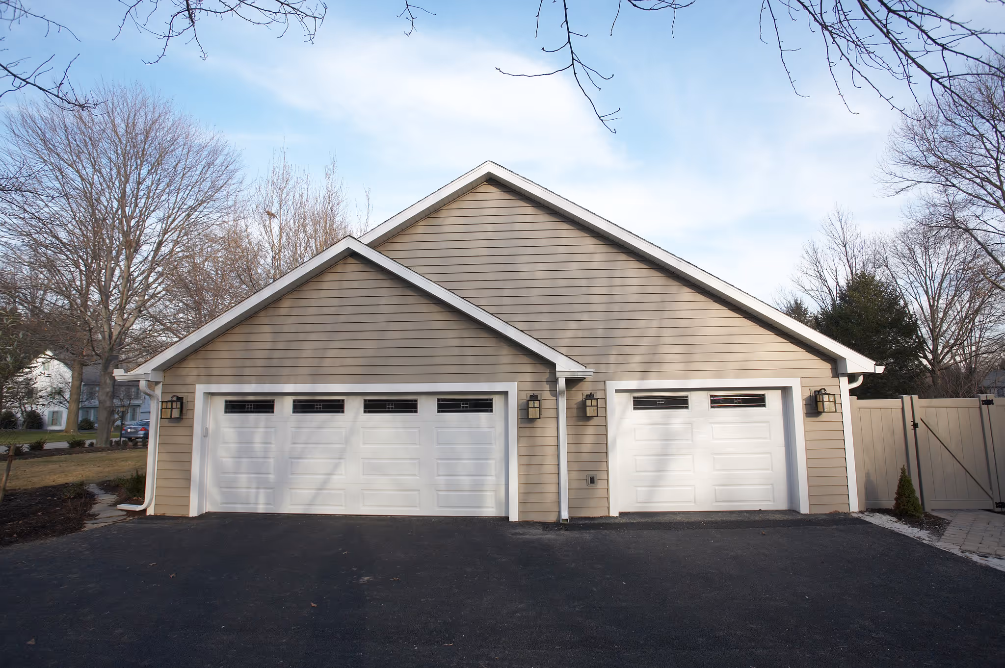 Contemporary garage exterior with white doors and beige siding in Camp Hill, PA