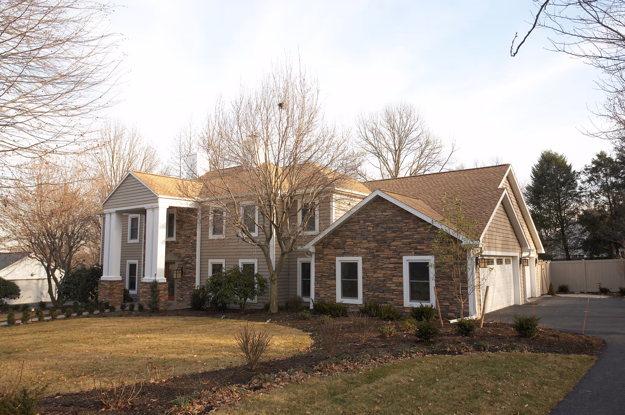 Stunning modern residential exterior featuring stone accents and landscaped garden in Camp Hill, PA.