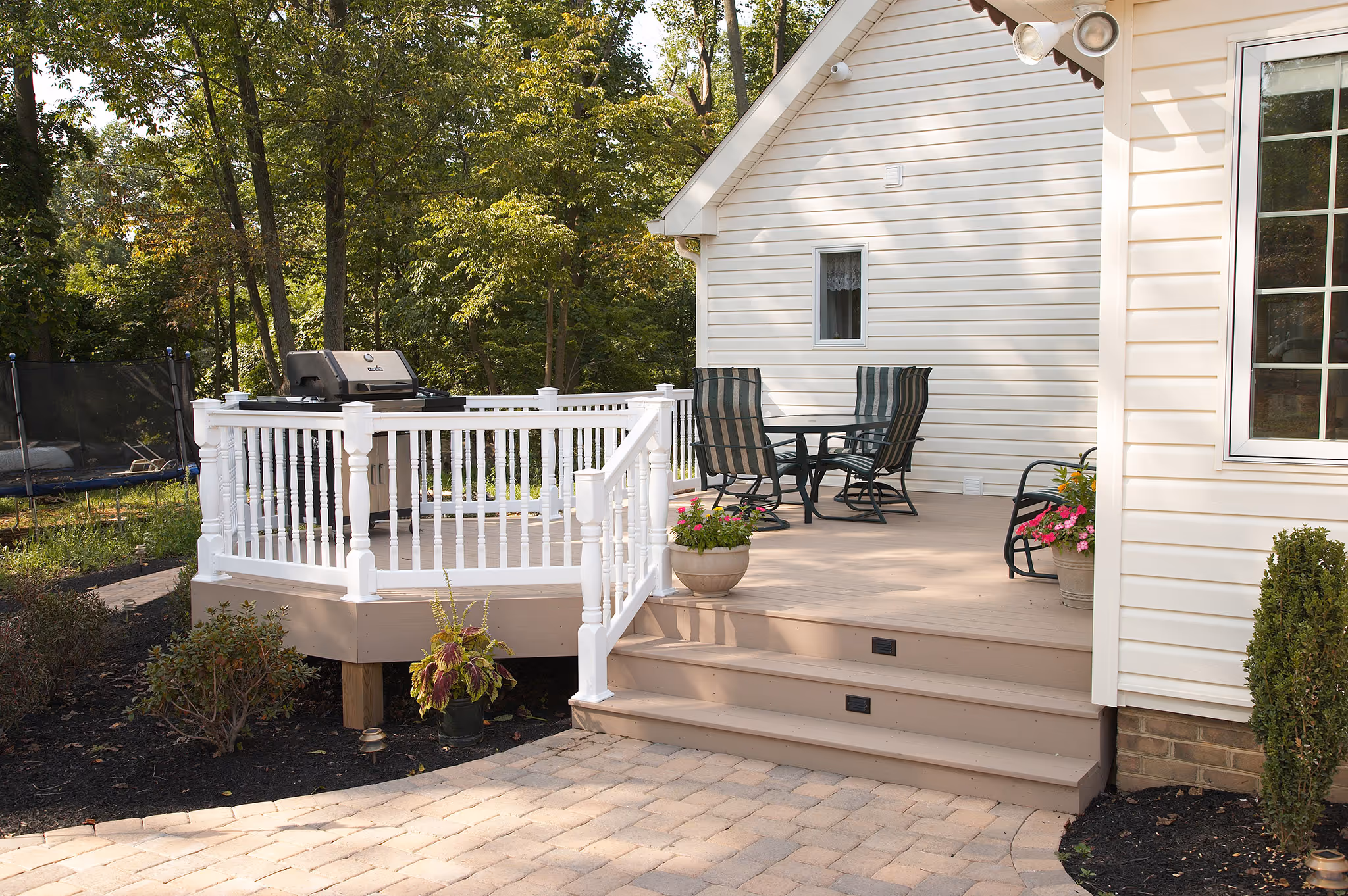Outdoor patio in Middletown, PA with a grill, seating area, and potted flowers.