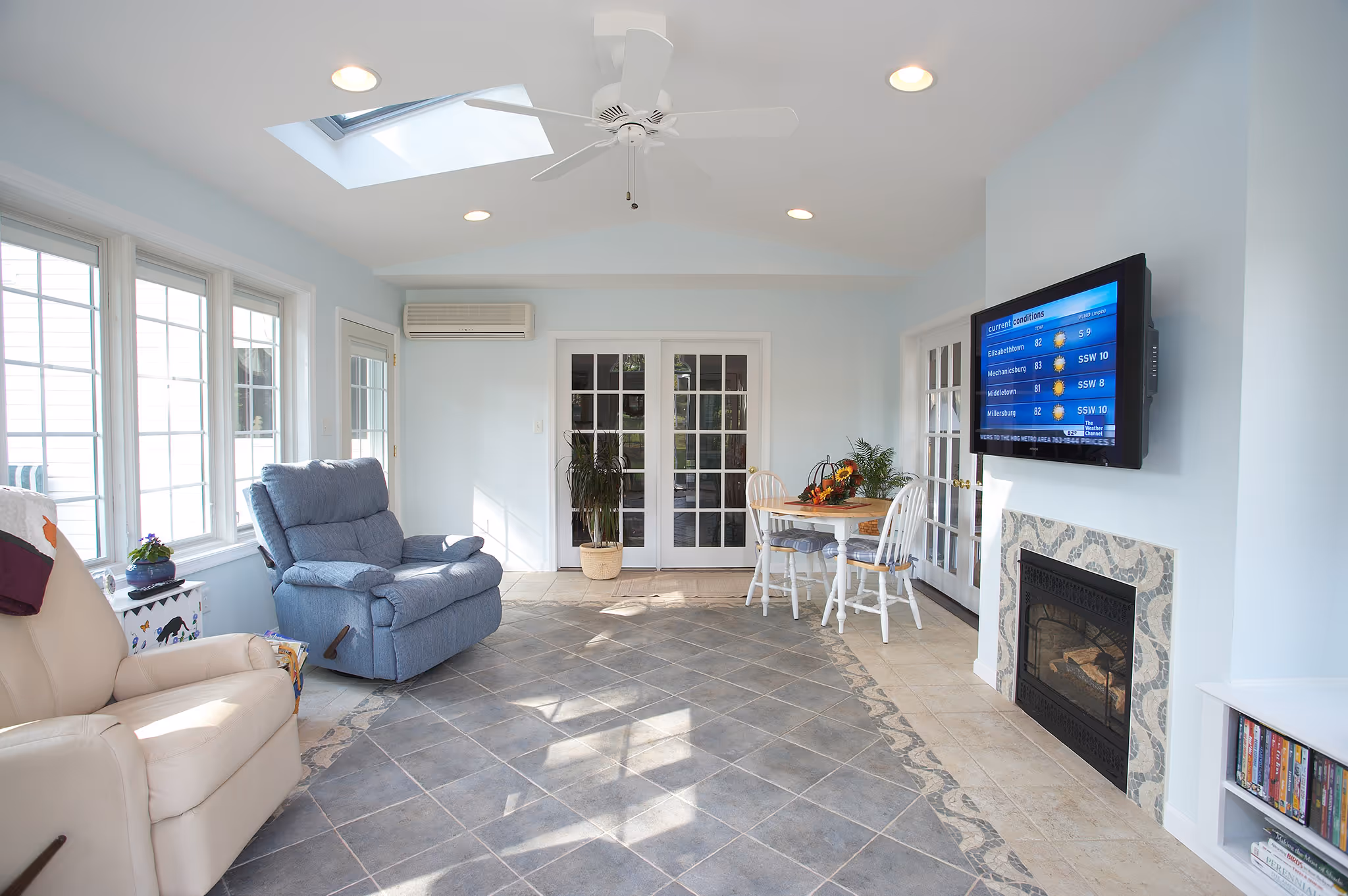 Light-filled sunroom in Middletown, PA featuring a cozy seating area and a modern dining space.