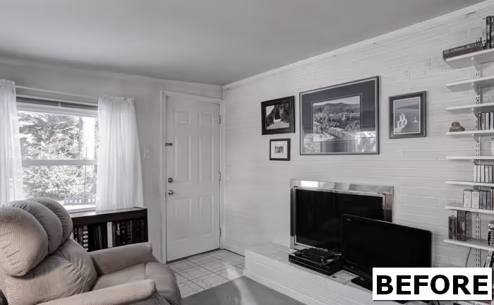 Cozy living room with white brick walls, large window, and black television setup in Camp Hill, PA.
