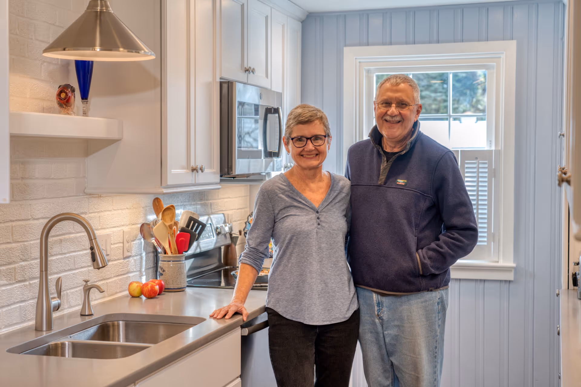 Modern kitchen in Camp Hill, PA, featuring sleek stainless steel appliances, white cabinetry, and a comfortable atmosphere.