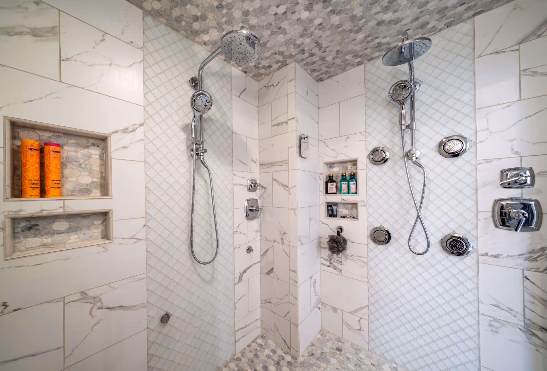 Modern bathroom shower with marble tiles and multiple showerheads in Elizabethtown, PA