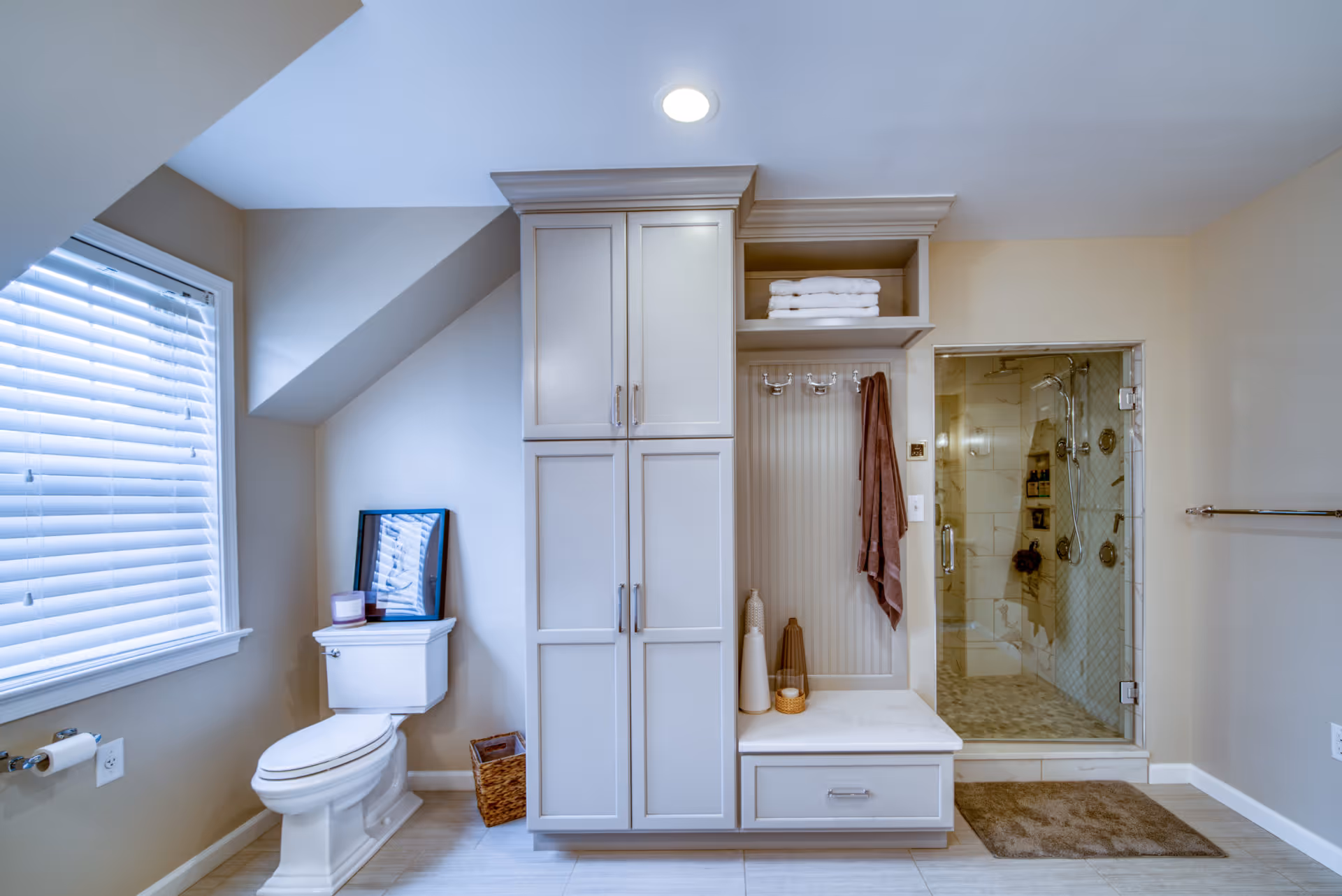 Modern bathroom in Elizabethtown, PA featuring gray cabinetry and a glass shower enclosure.
