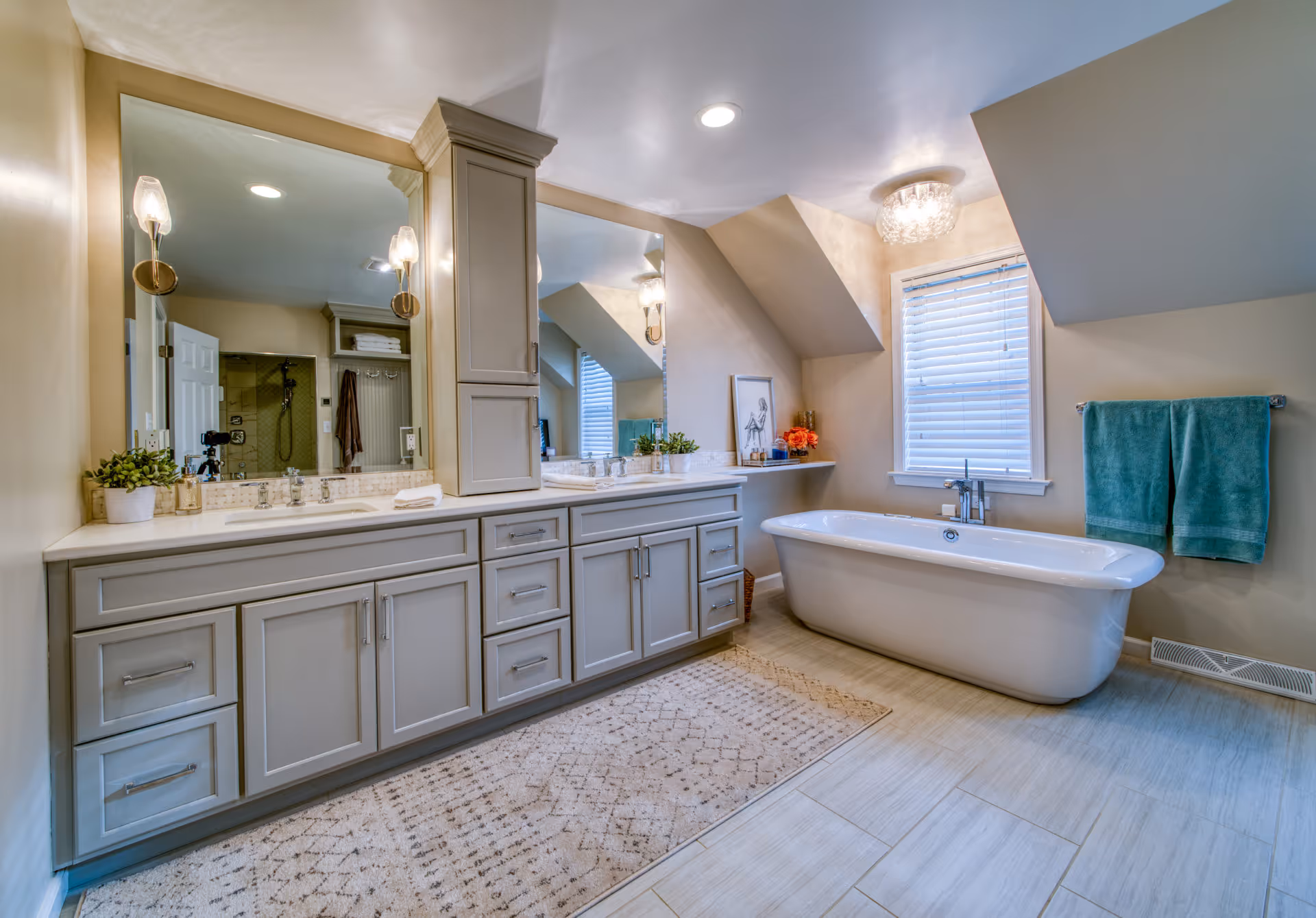 Elegant bathroom in Elizabethtown, PA with gray cabinetry, freestanding tub, and stylish lighting.