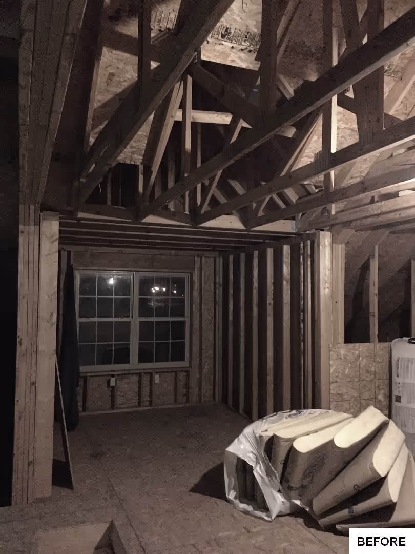 Roughly framed attic space before renovation in Elizabethtown, PA, featuring wooden beams and construction materials.