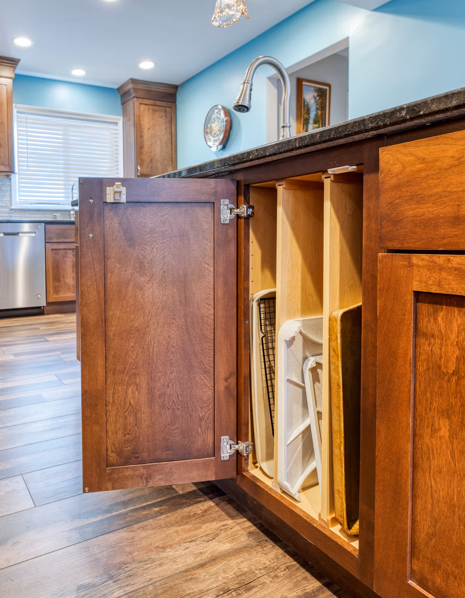 Modern kitchen storage cabinet in Hershey, PA featuring organized interior with wooden cabinet doors and functional design.