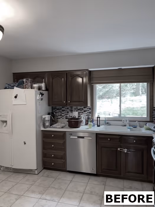 Before kitchen renovation in Hershey, PA featuring wooden cabinets, stainless steel appliances, and tile flooring.
