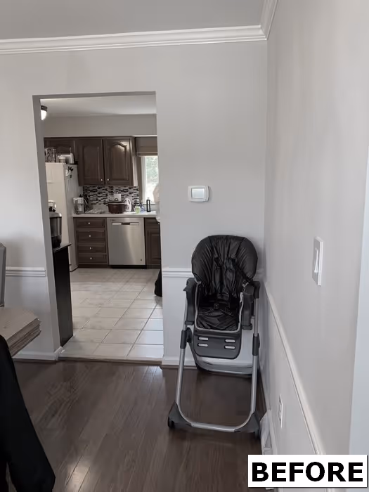 Before image of a modern kitchen in Hershey, PA, featuring dark wood cabinets and an adjacent high chair