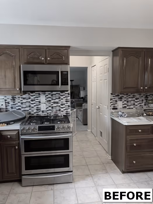 Before renovation of a transitional kitchen with dark wood cabinets and stainless steel appliances in hershey, pa.