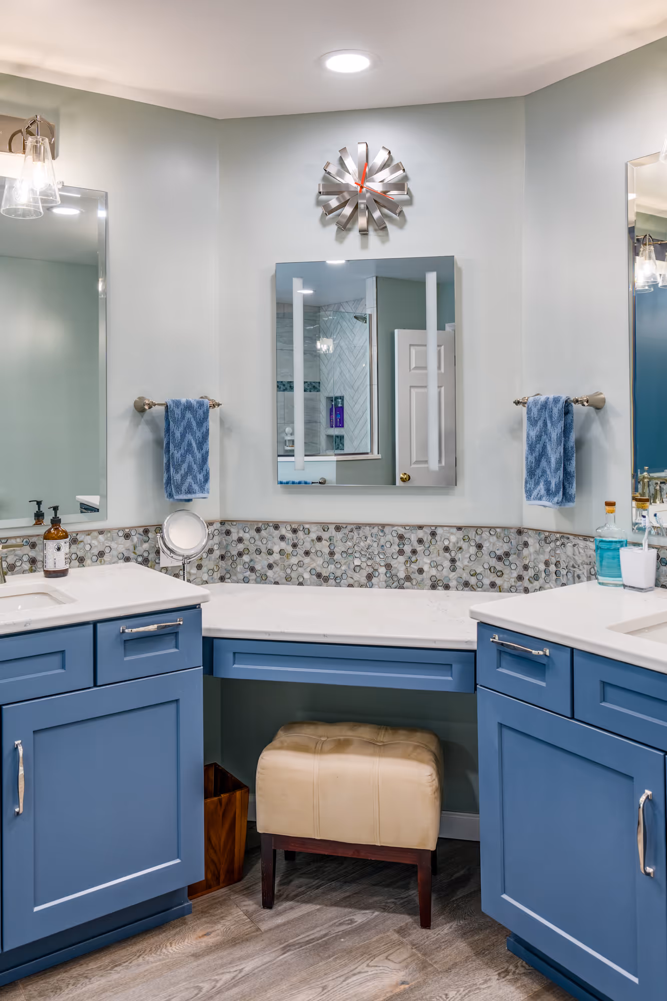 Stylish blue cabinetry bathroom with decorative tile and modern mirrors in enola, pa