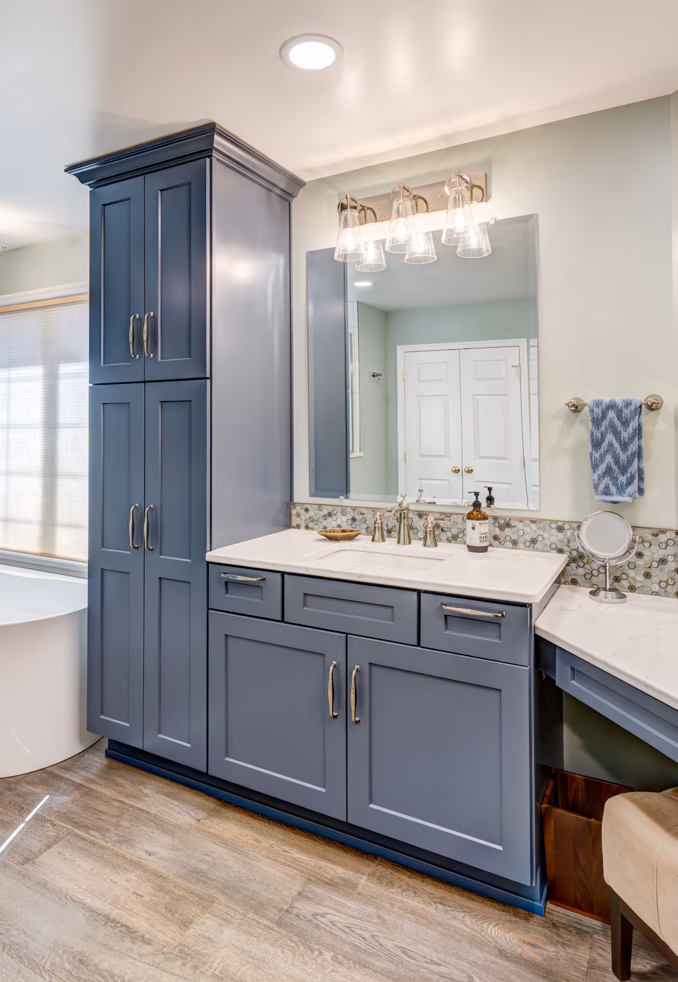 Contemporary bathroom featuring navy blue cabinets and a white marble countertop in Enola, PA.