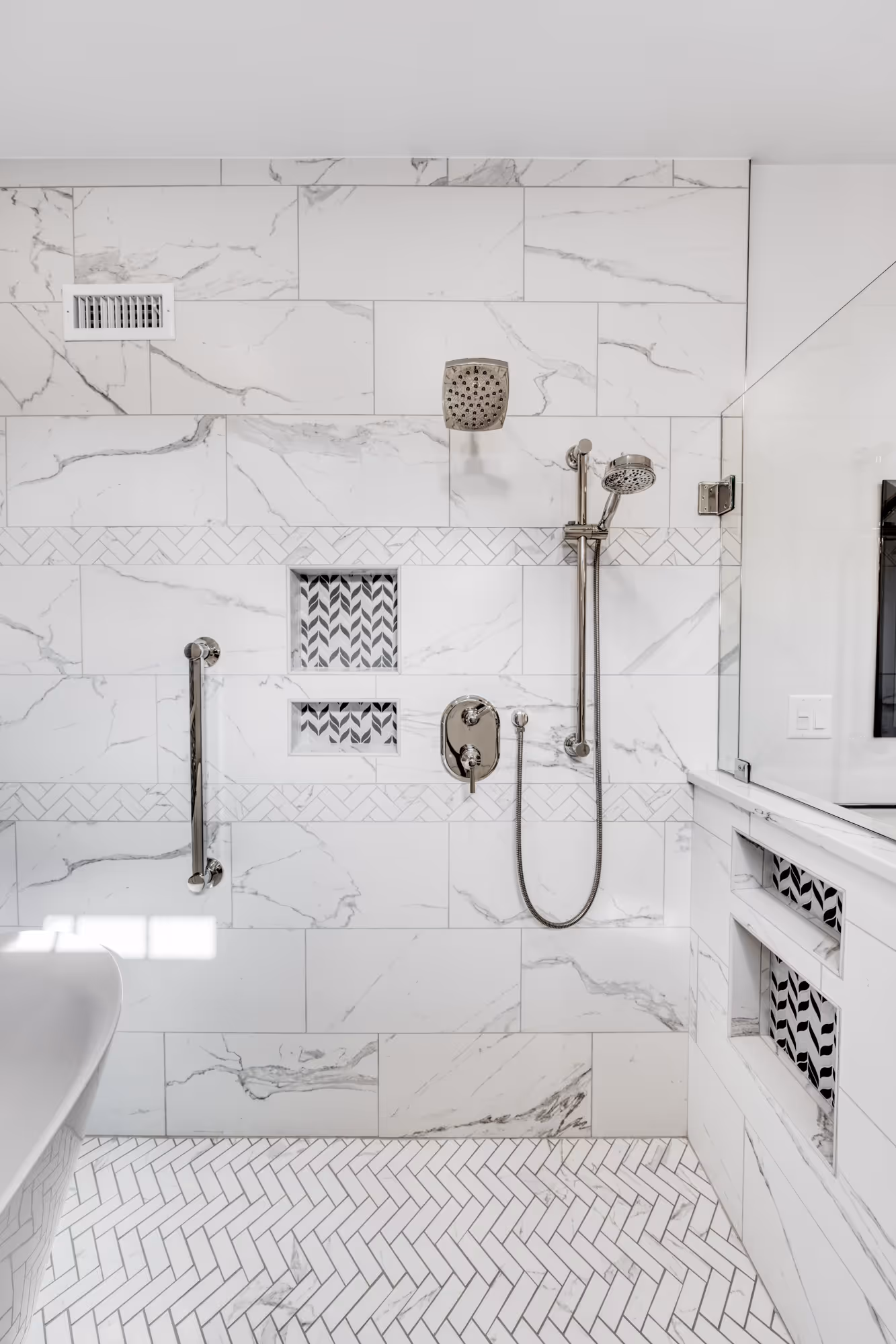 Stylish bathroom remodel in Camp Hill, PA, featuring a shower and bath combination with marble tiles and modern fixtures.