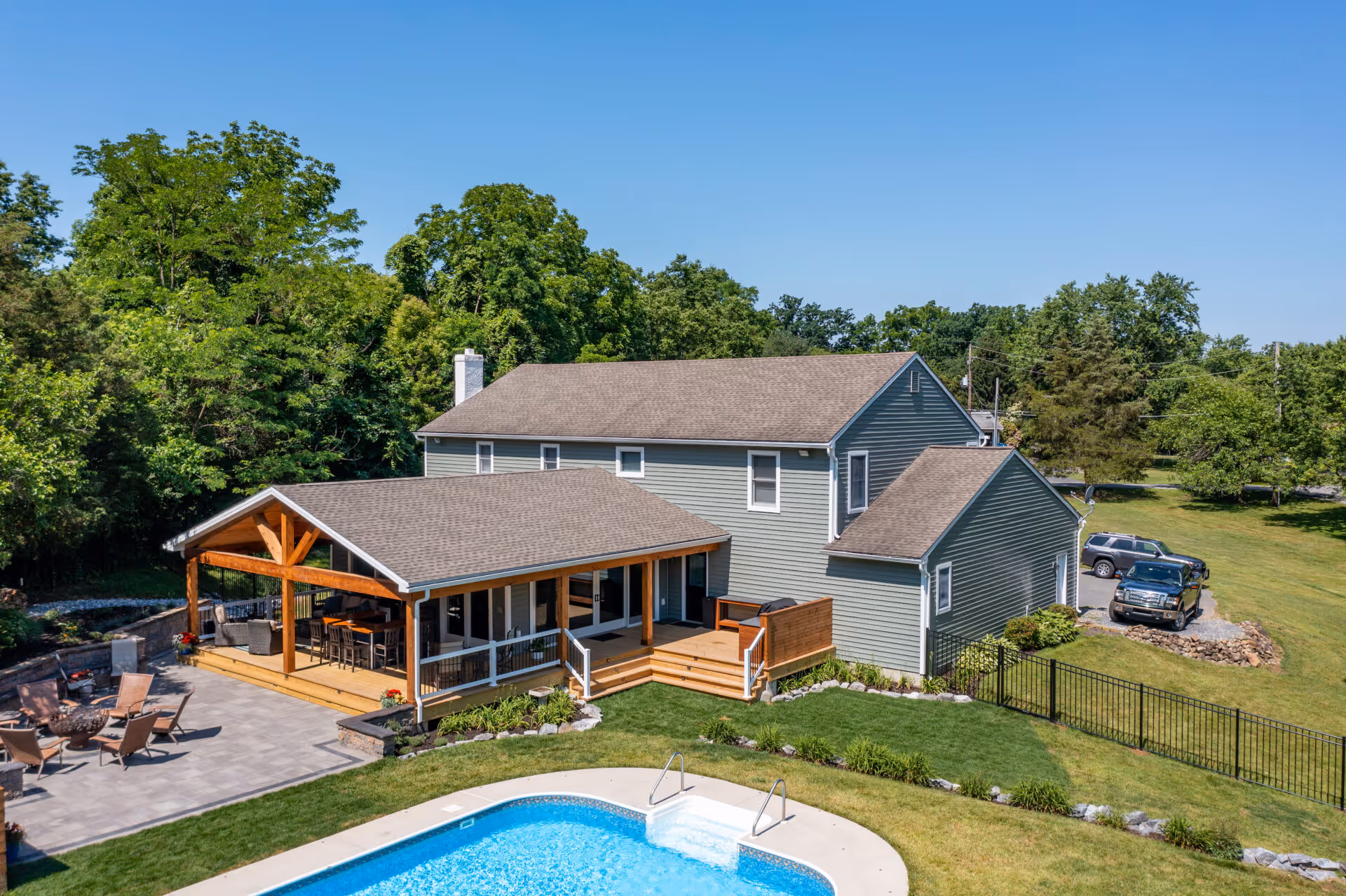Beautiful modern exterior view of a house with a pool and outdoor entertaining space in Dillsburg, PA