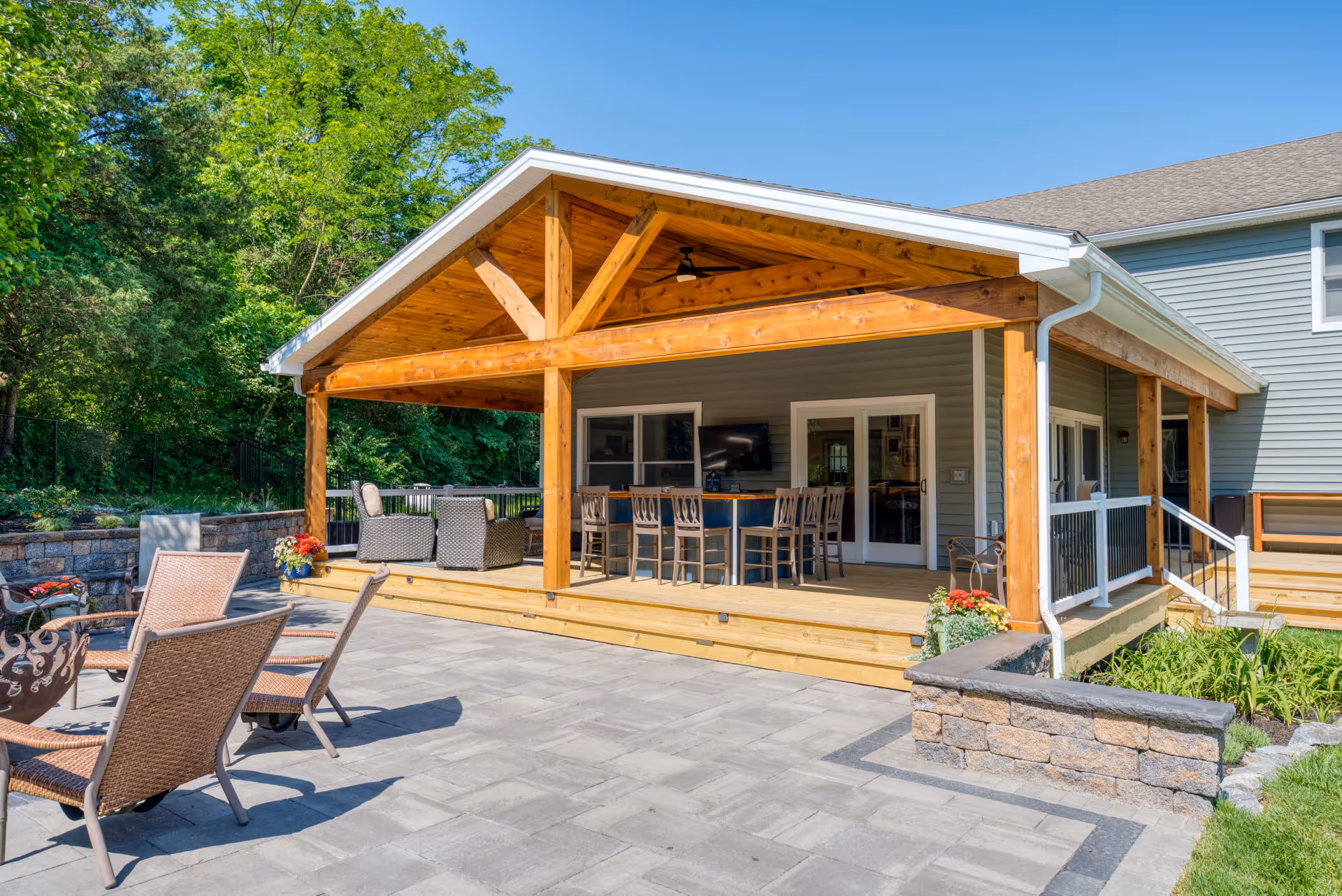 Spacious outdoor living area featuring a wooden pergola and stone patio in Dillsburg, PA.
