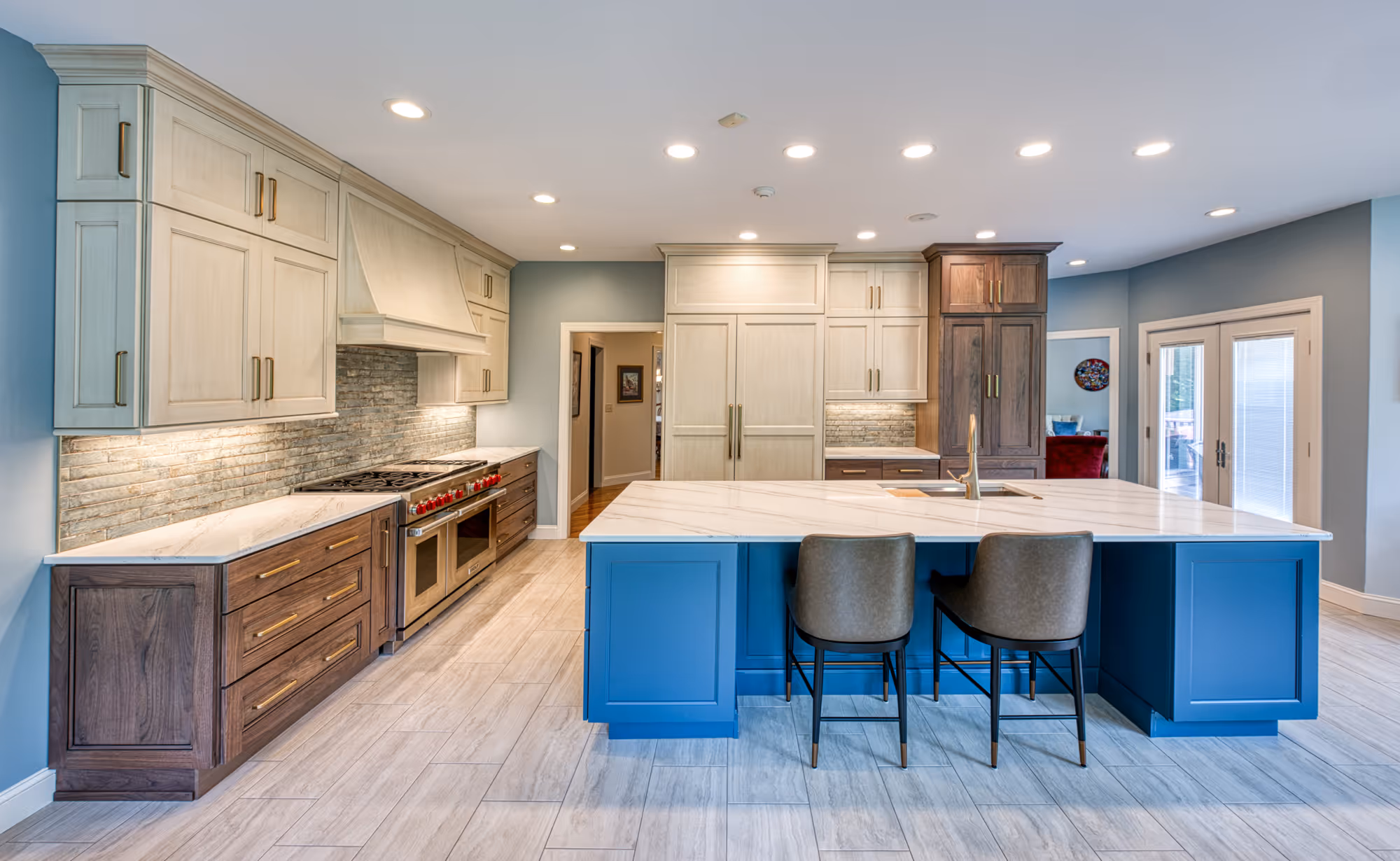 Contemporary kitchen with blue island, white cabinets, and wood accents in Mechanicsburg, PA.