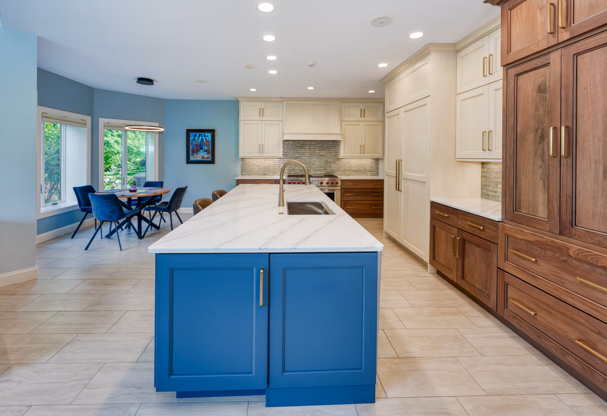Contemporary kitchen in mechanicsburg, pa featuring a blue island, light wood cabinetry, and modern fixtures