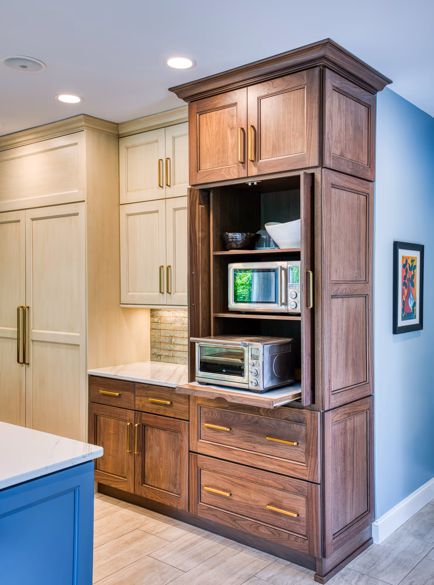 Modern kitchen design featuring wooden cabinets with gold handles, sleek countertops, and recessed lighting in Mechanicsburg, PA.