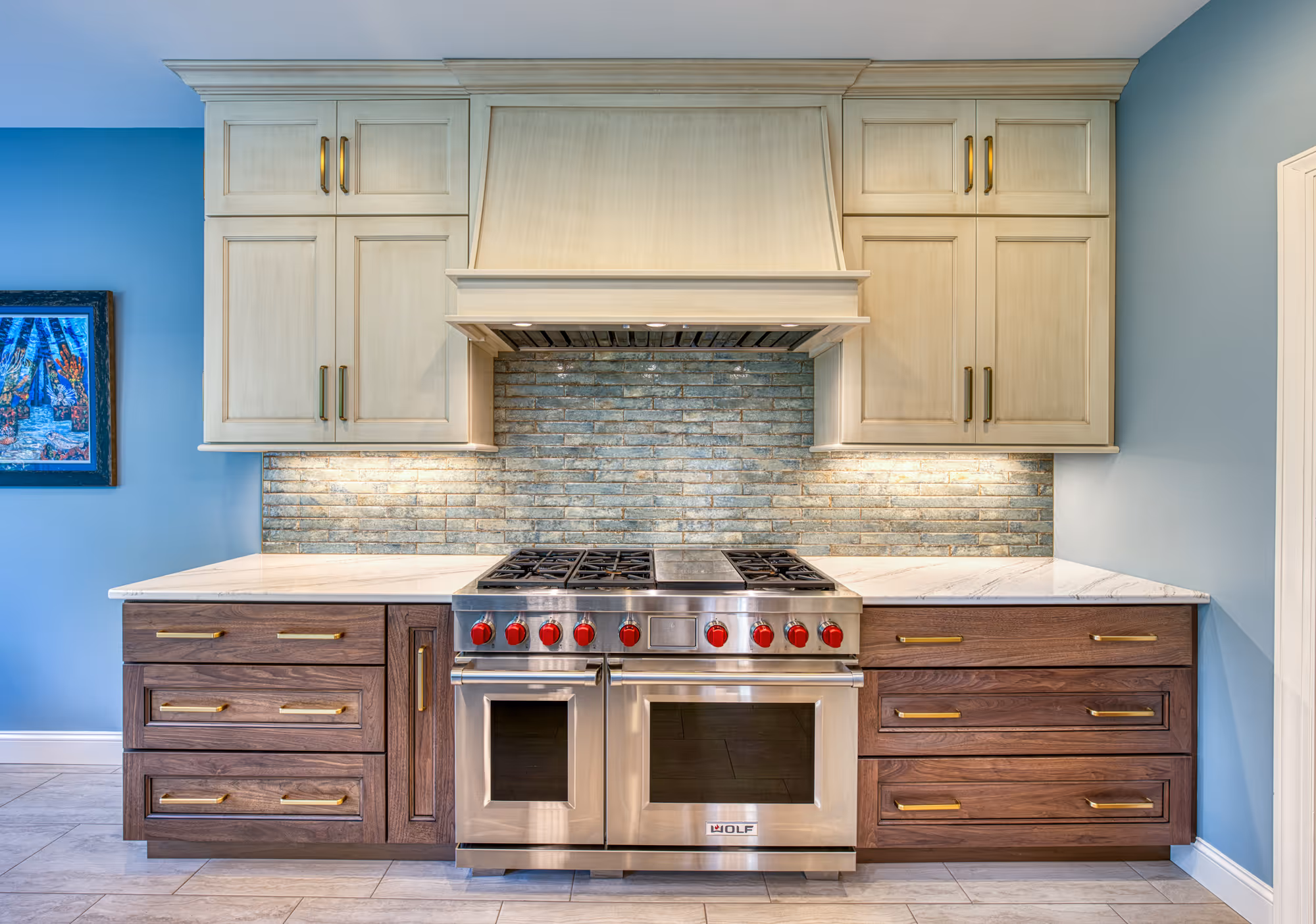 Modern kitchen with a blue accent wall, wood cabinetry, a stainless steel range, and stone backsplash in mechanicsburg, pa.
