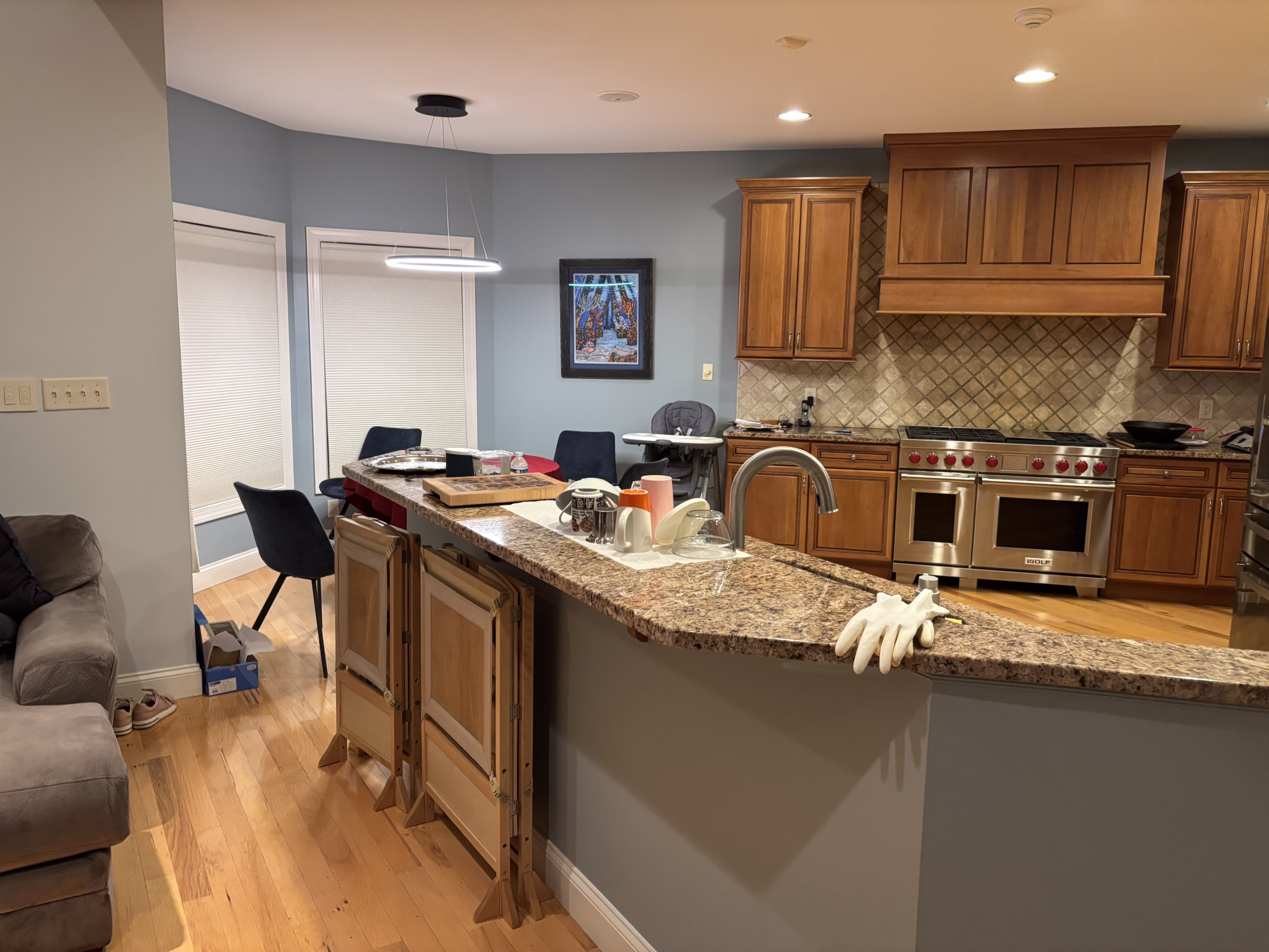 Spacious kitchen in Mechanicsburg, PA featuring wooden cabinets, granite countertops, and stylish seating.