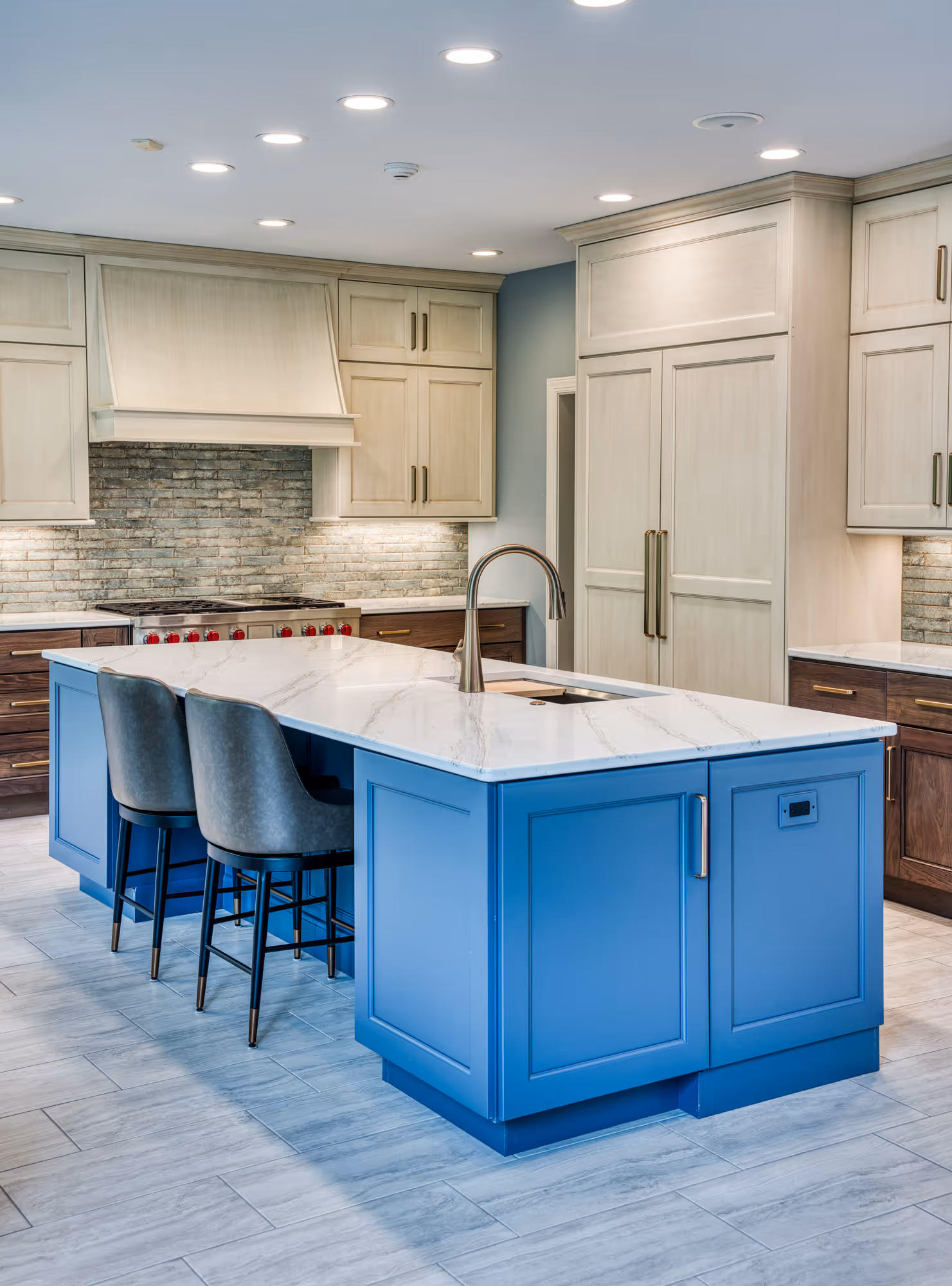 Modern kitchen remodel with blue island, white marble countertop, and gray accents in mechanicsburg, pa.
