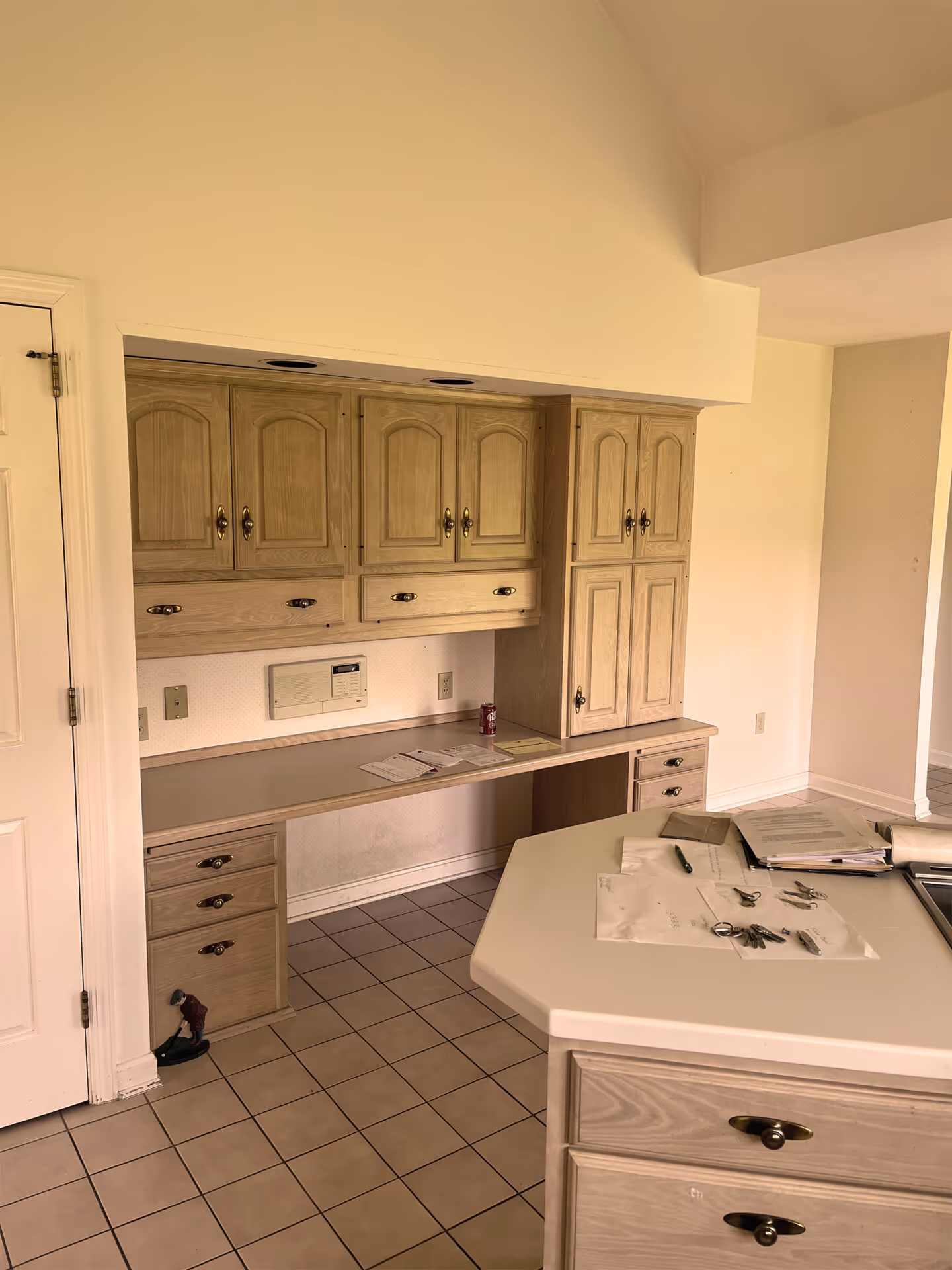 Light wood cabinetry and white countertop in a kitchen with a workspace in Enola, PA.