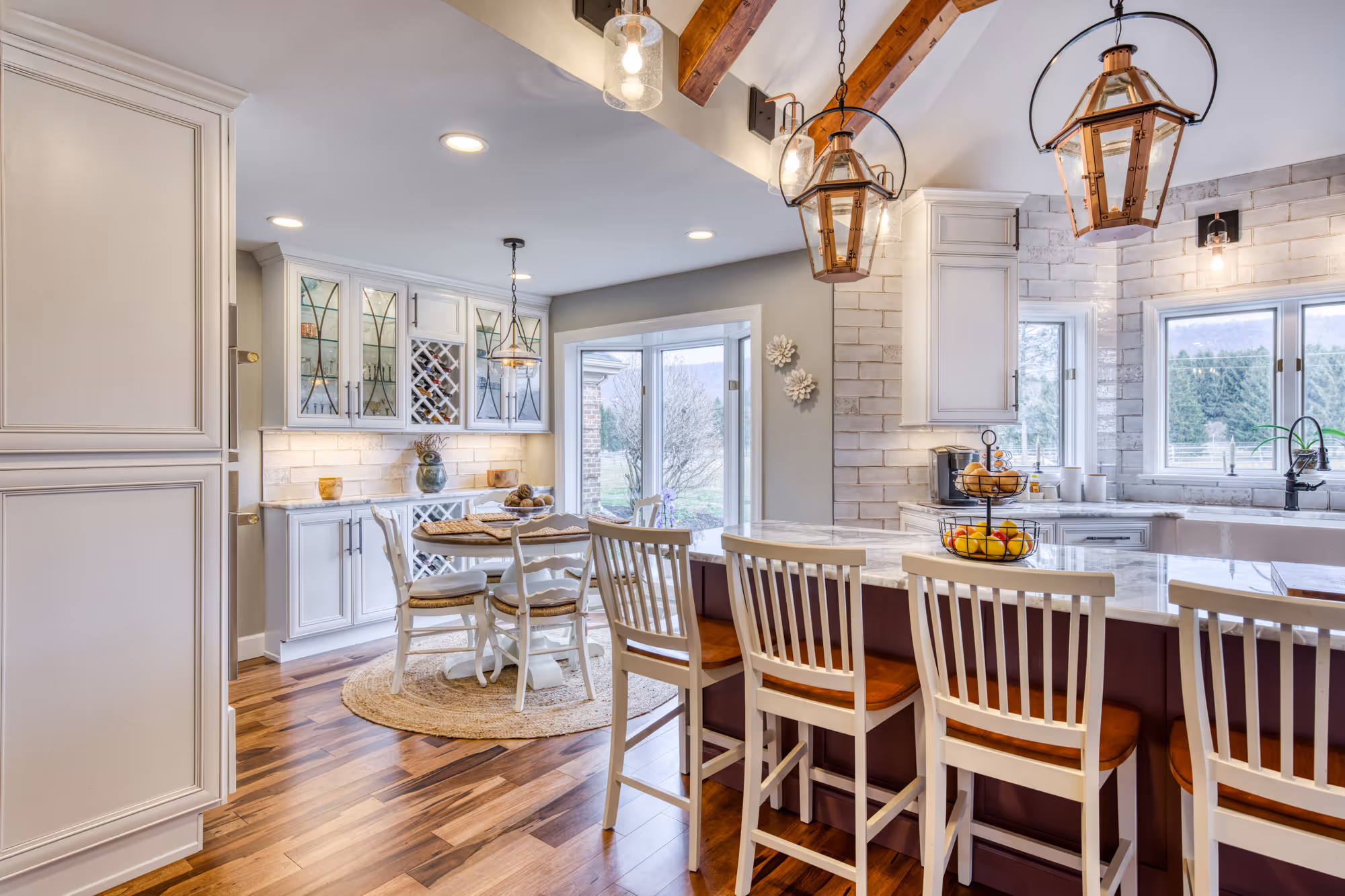 Bright modern kitchen featuring white cabinetry, wooden accents, and elegant lighting details in enola, pa.