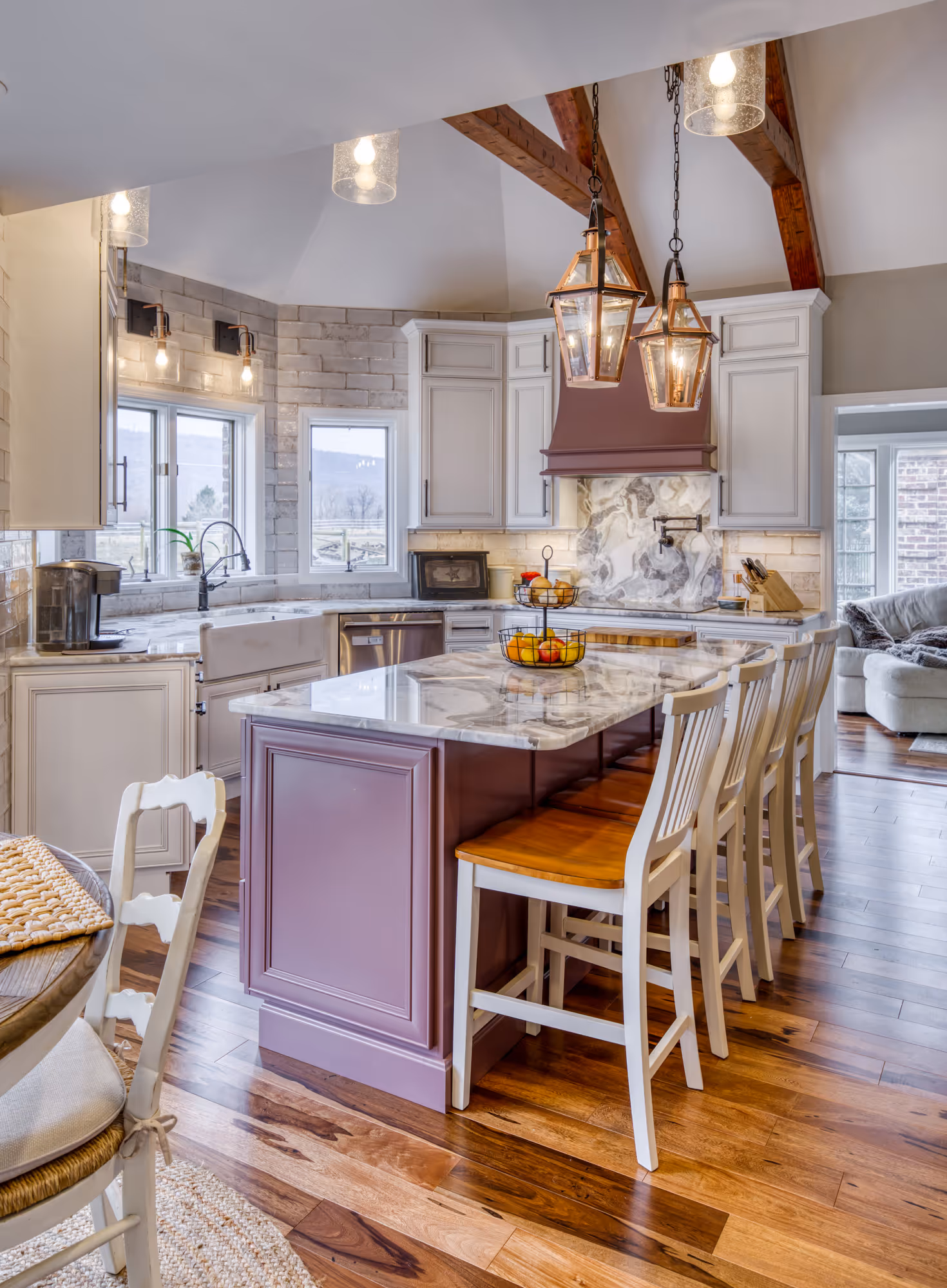 Elegant kitchen remodel in enola, pa featuring marble countertops, purple cabinetry, and pendant lighting.