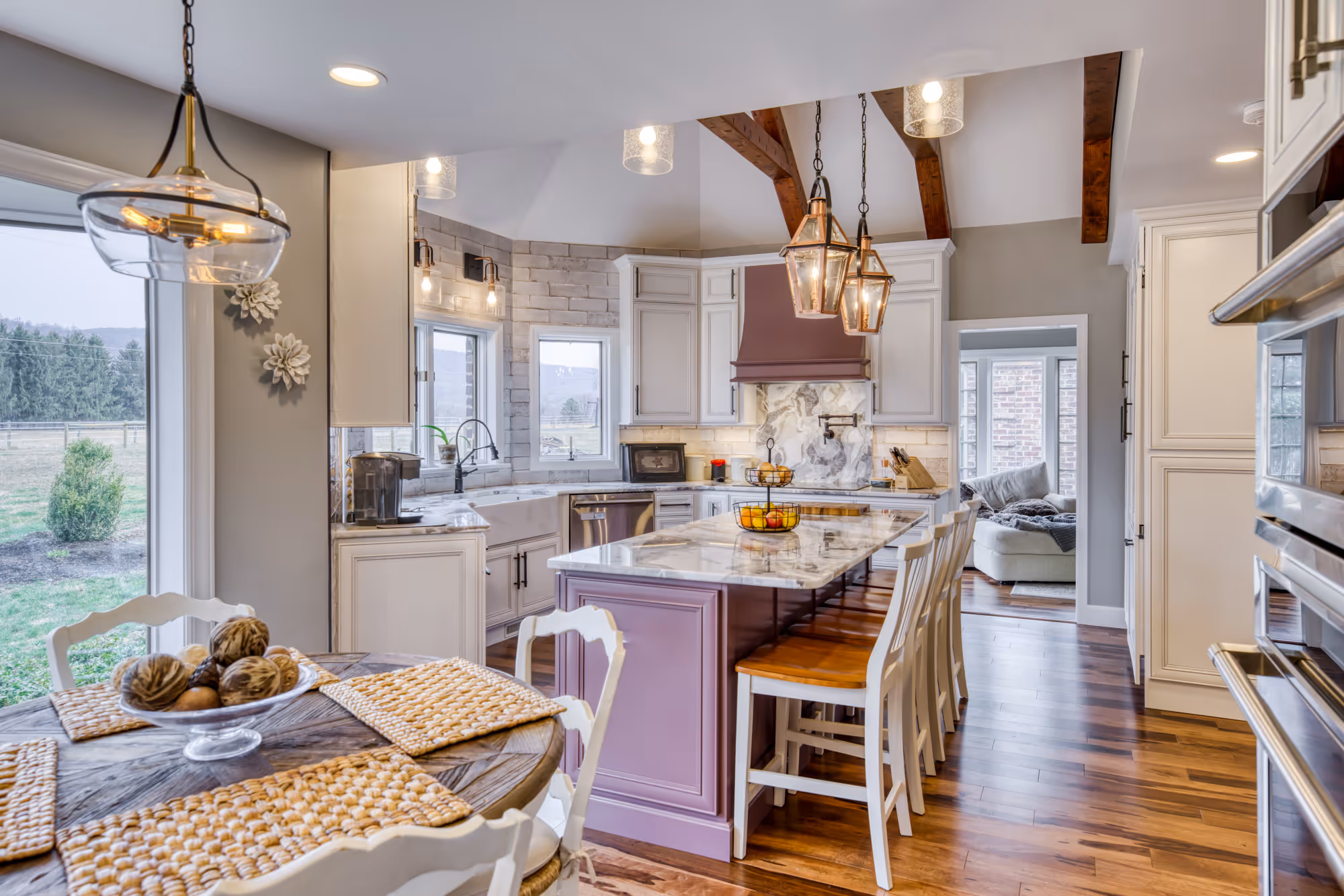 Modern kitchen in enola, pa with purple island, marble countertops, and wooden accents, blending elegance and warmth.