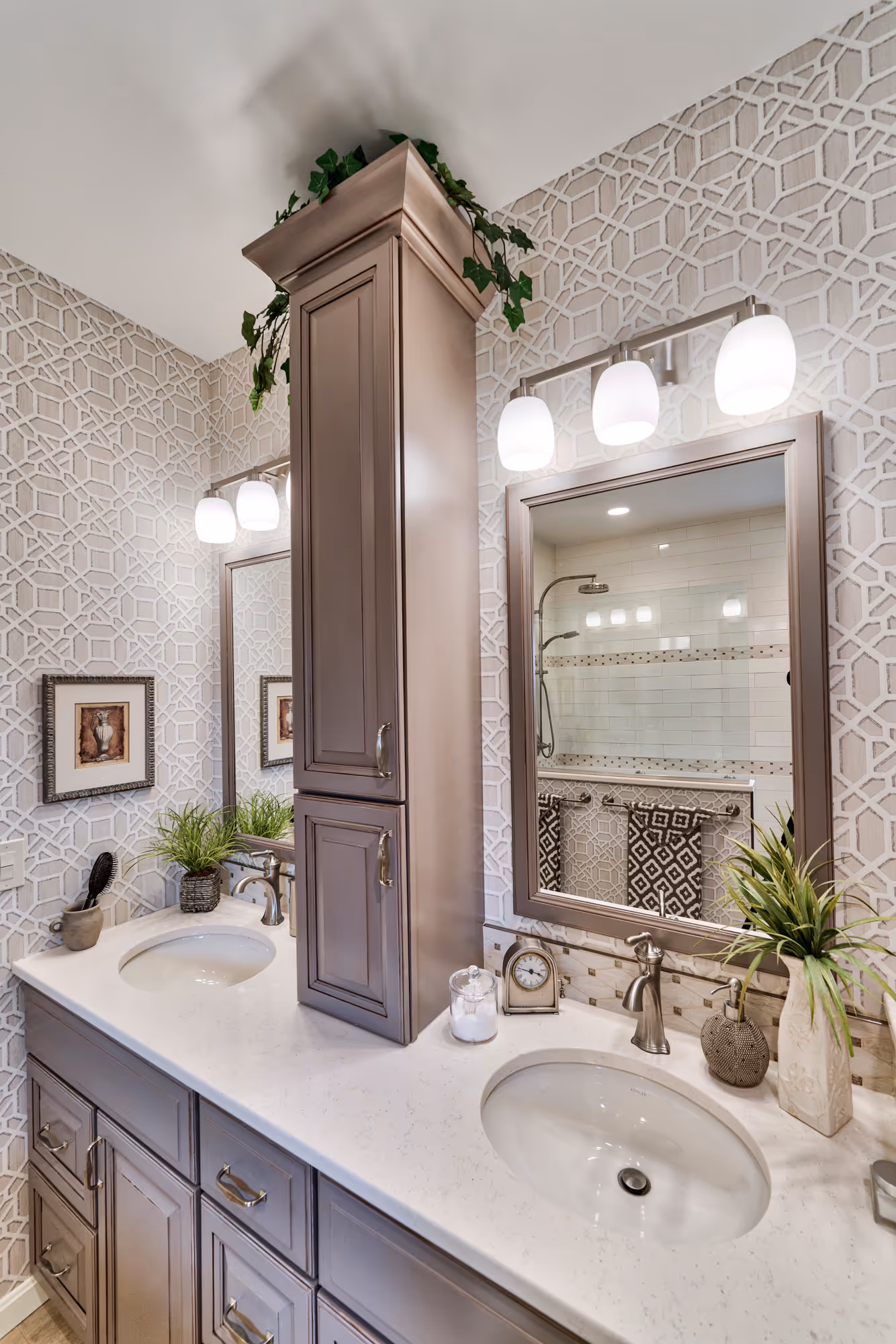 Luxury bathroom with dual vanities, decorative mirrors, and geometric wallpaper in Hershey, PA.