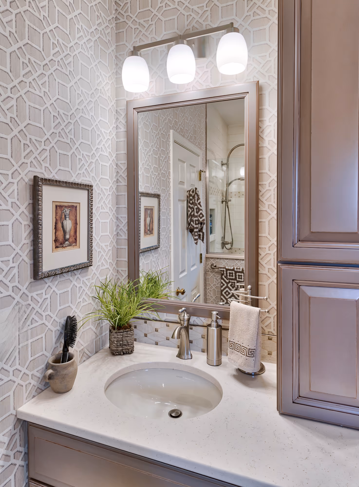 Elegant bathroom with geometric wallpaper, a round sink, and modern fixtures in Hershey, PA.