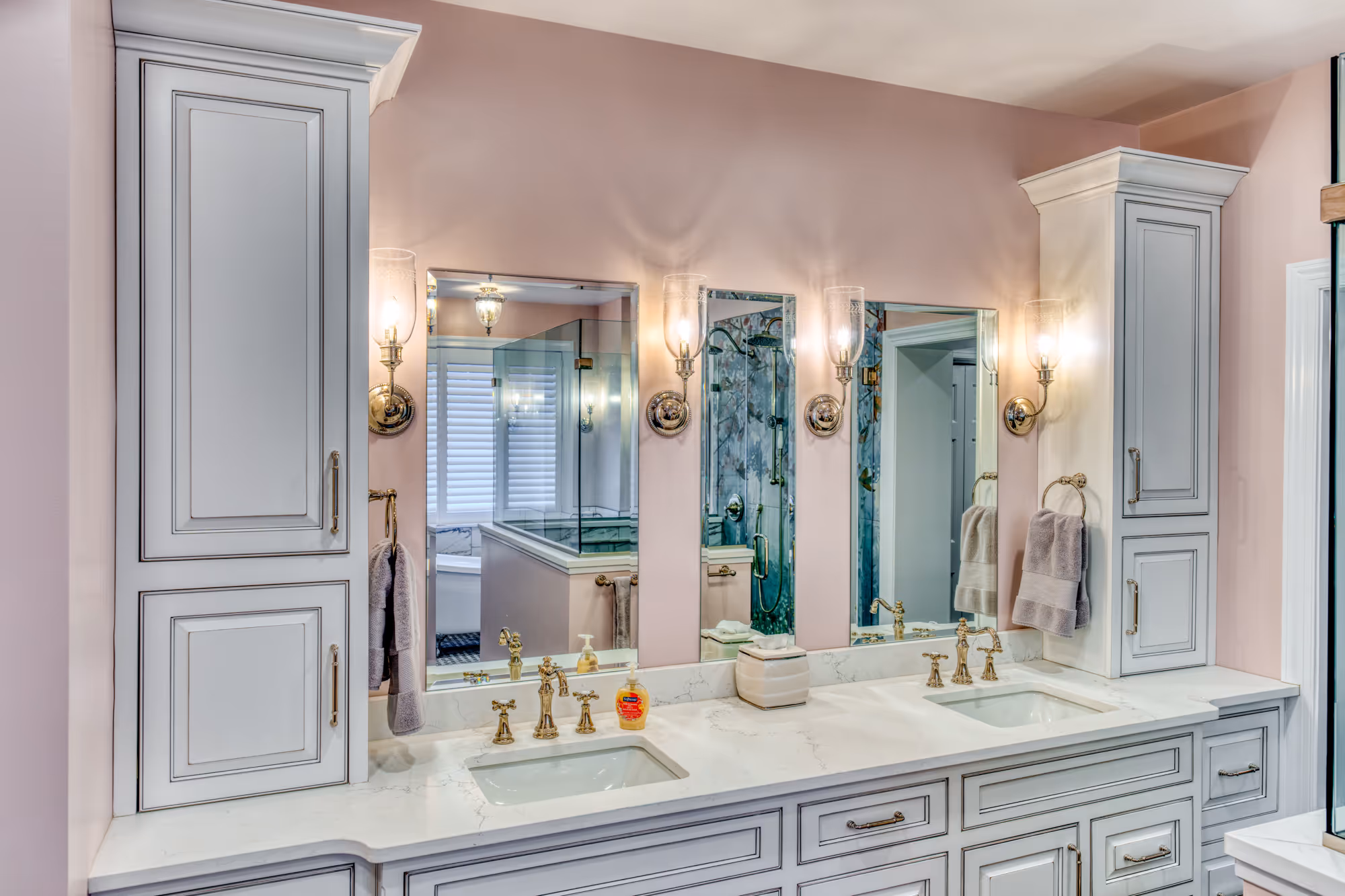Elegant modern bathroom with dual sinks, marble countertop, and pink walls in mechanicsburg, pa.