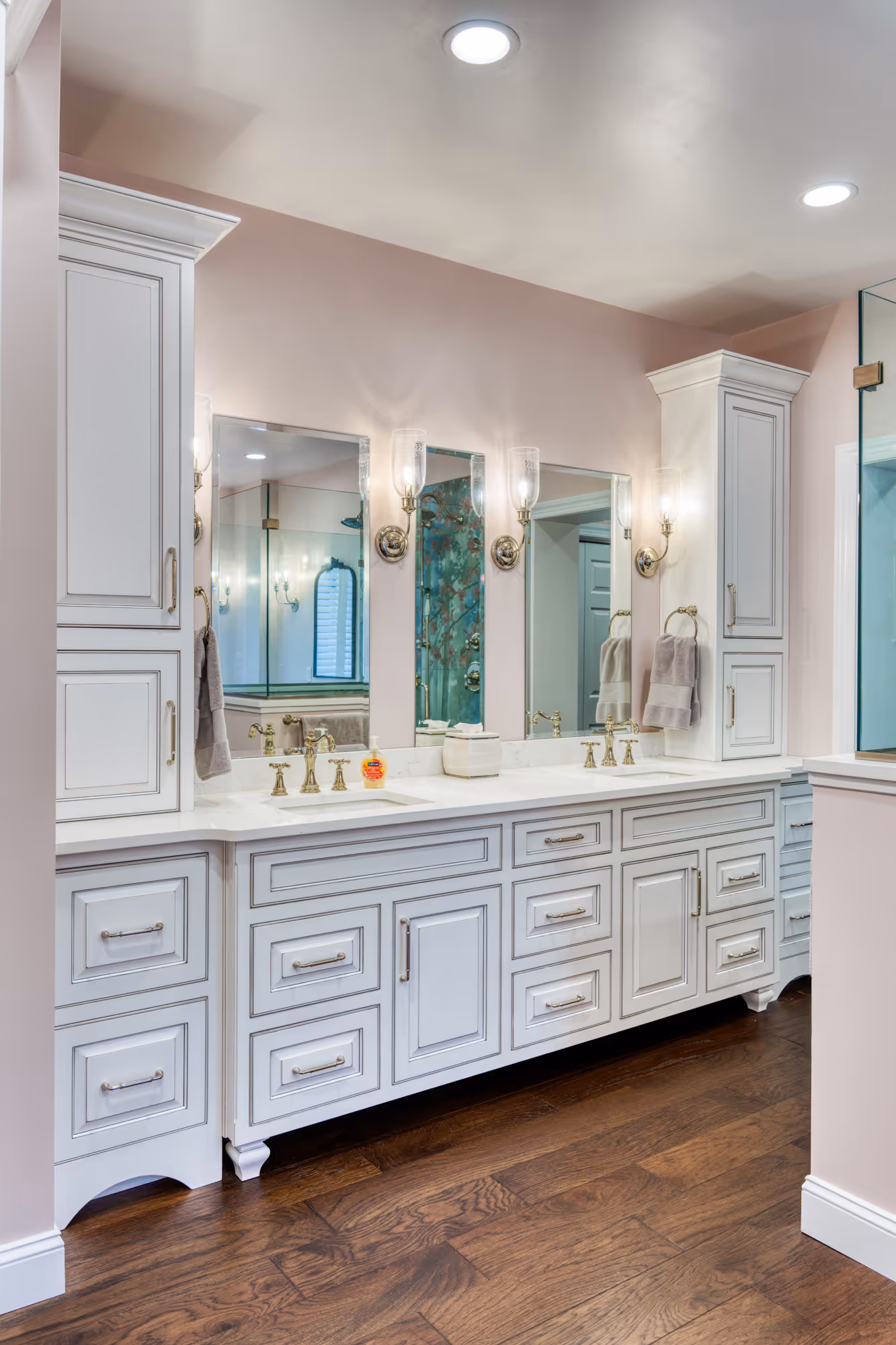 Modern pink bathroom in Mechanicsburg, PA featuring white cabinetry, marble countertop, and elegant lighting.