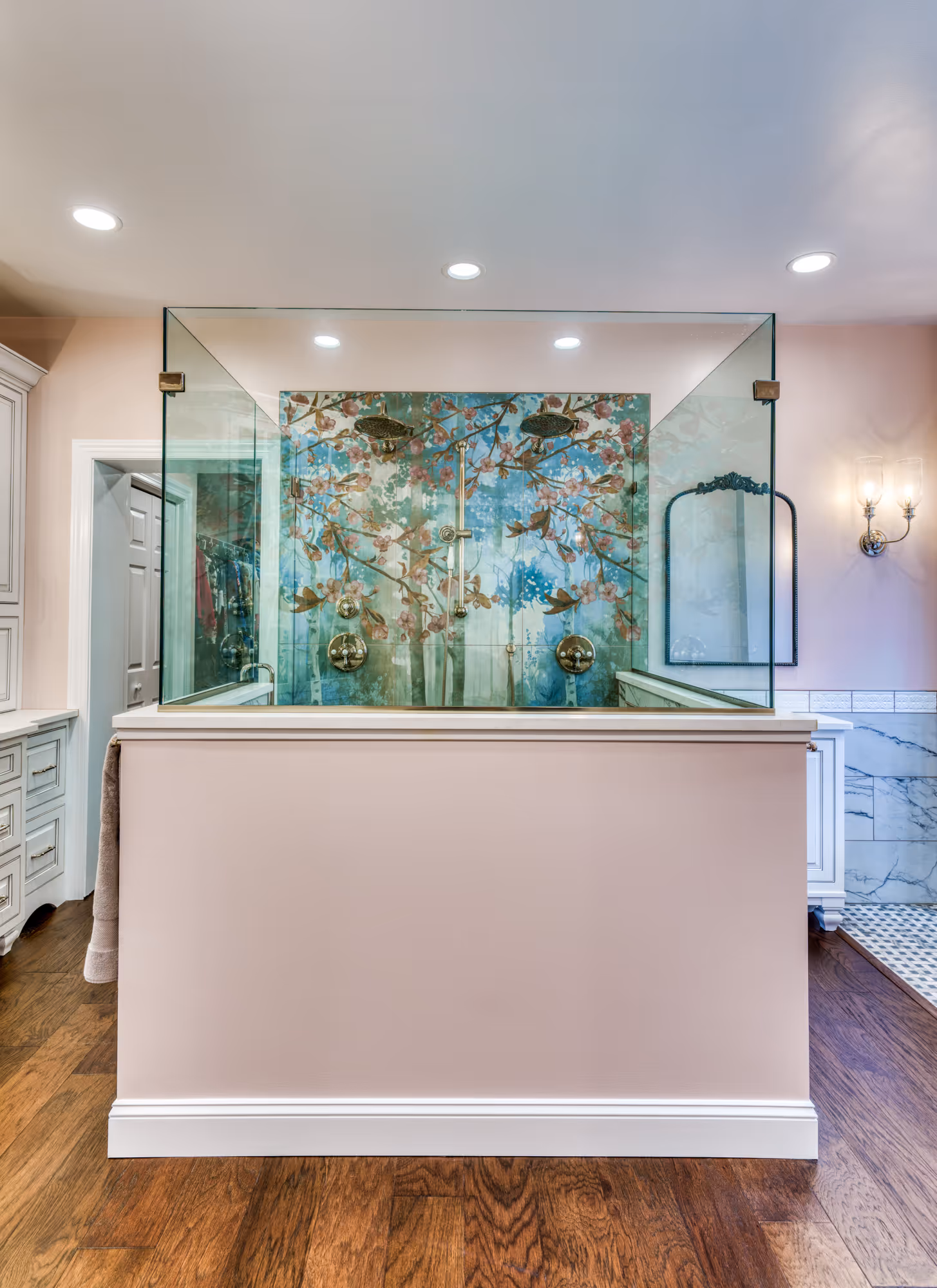 Luxury bathroom in Mechanicsburg, PA featuring dual shower heads and floral mural backsplash.