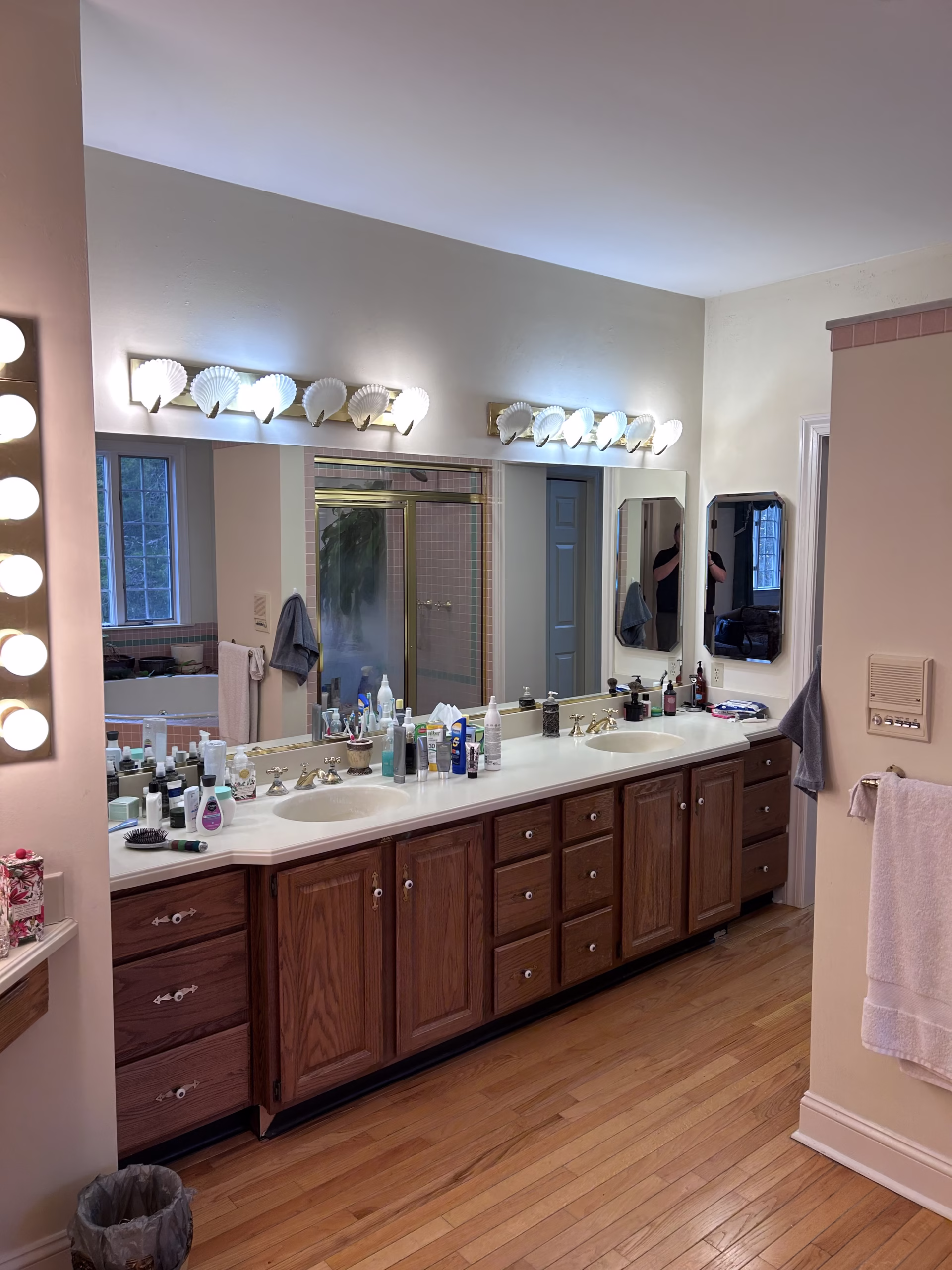 Primary bathroom with double vanity and wooden cabinets, featuring a large mirror and ample lighting in mechanicsburg, pa