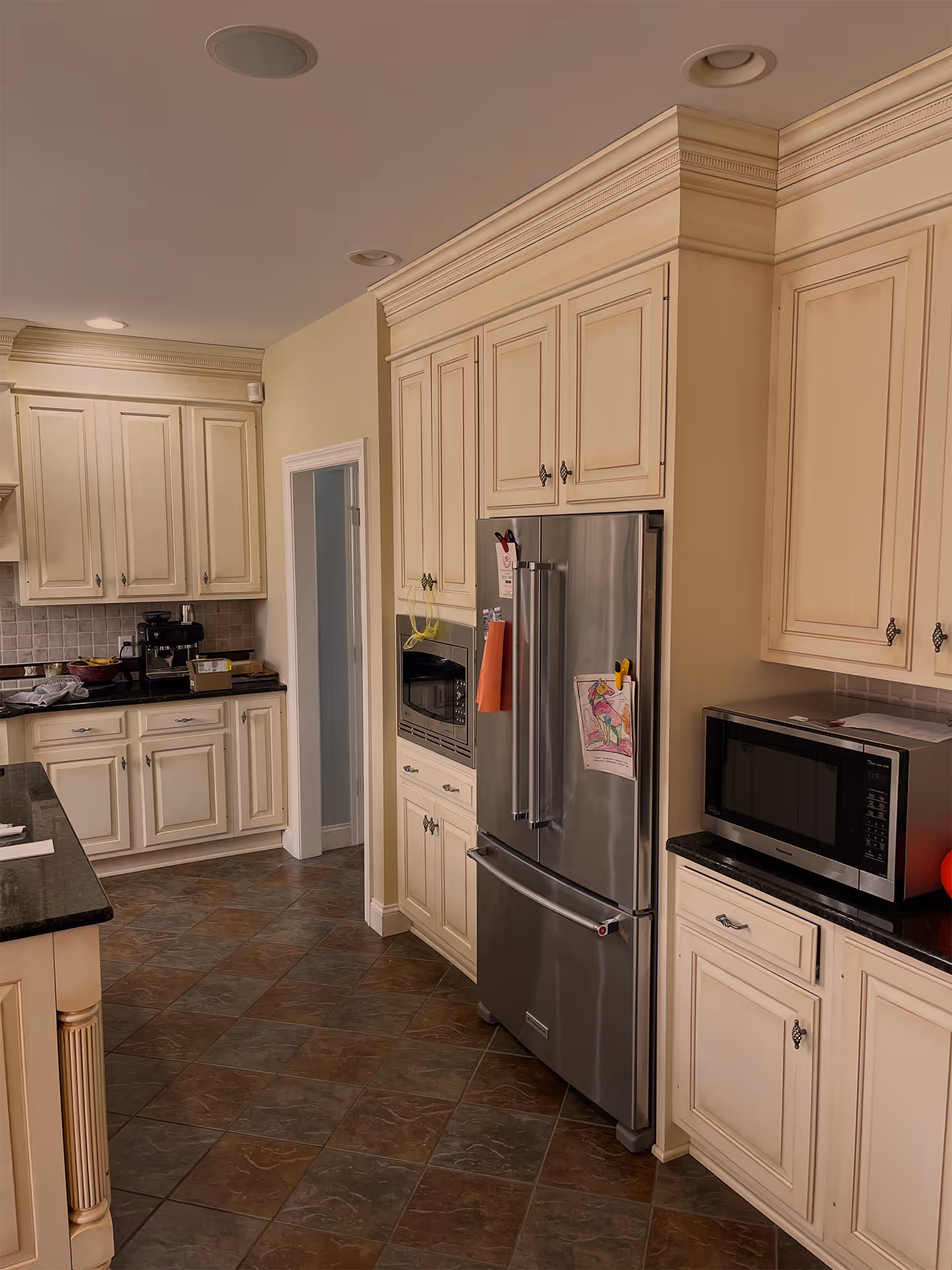 Spacious transitional kitchen in lewisberry, pa featuring cream-colored cabinets, granite countertops, and modern appliances.