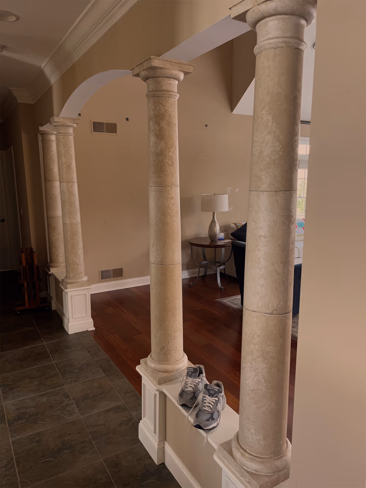 Elegant entryway featuring decorative columns and hardwood floors in lewisberry, pa