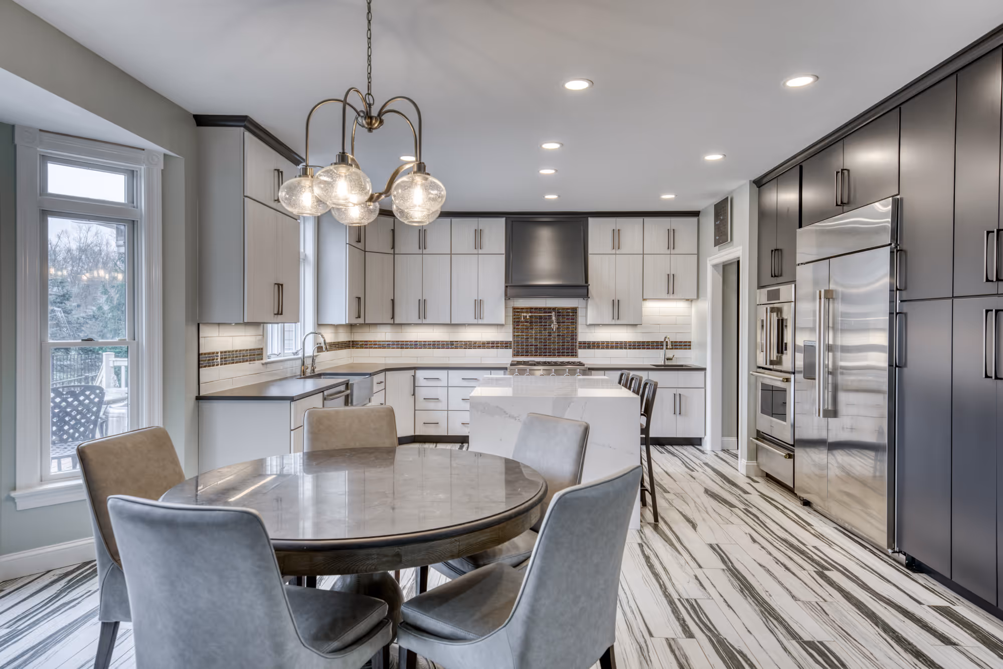Modern kitchen featuring gray and white cabinetry with an island, located in Lewisberry, PA.