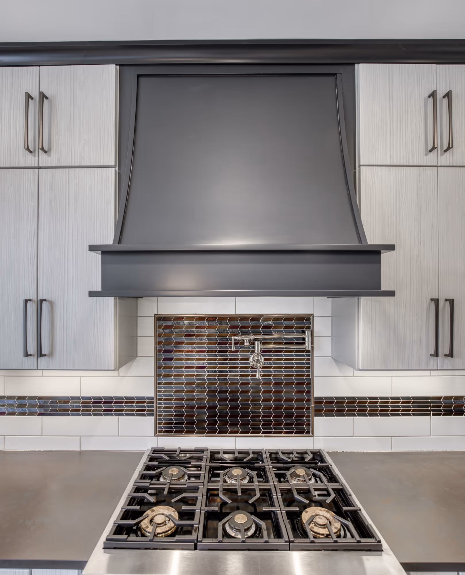 Modern kitchen design featuring a sleek gas cooktop and stylish tile backsplash in lewisberry, pa