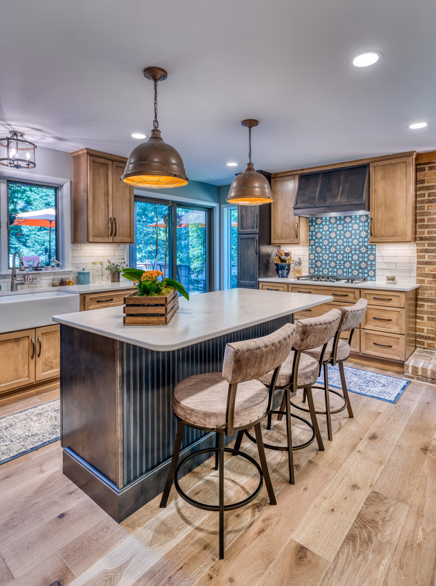 Contemporary kitchen with a large island, wood cabinets, and stylish pendant lights in Harrisburg, PA.