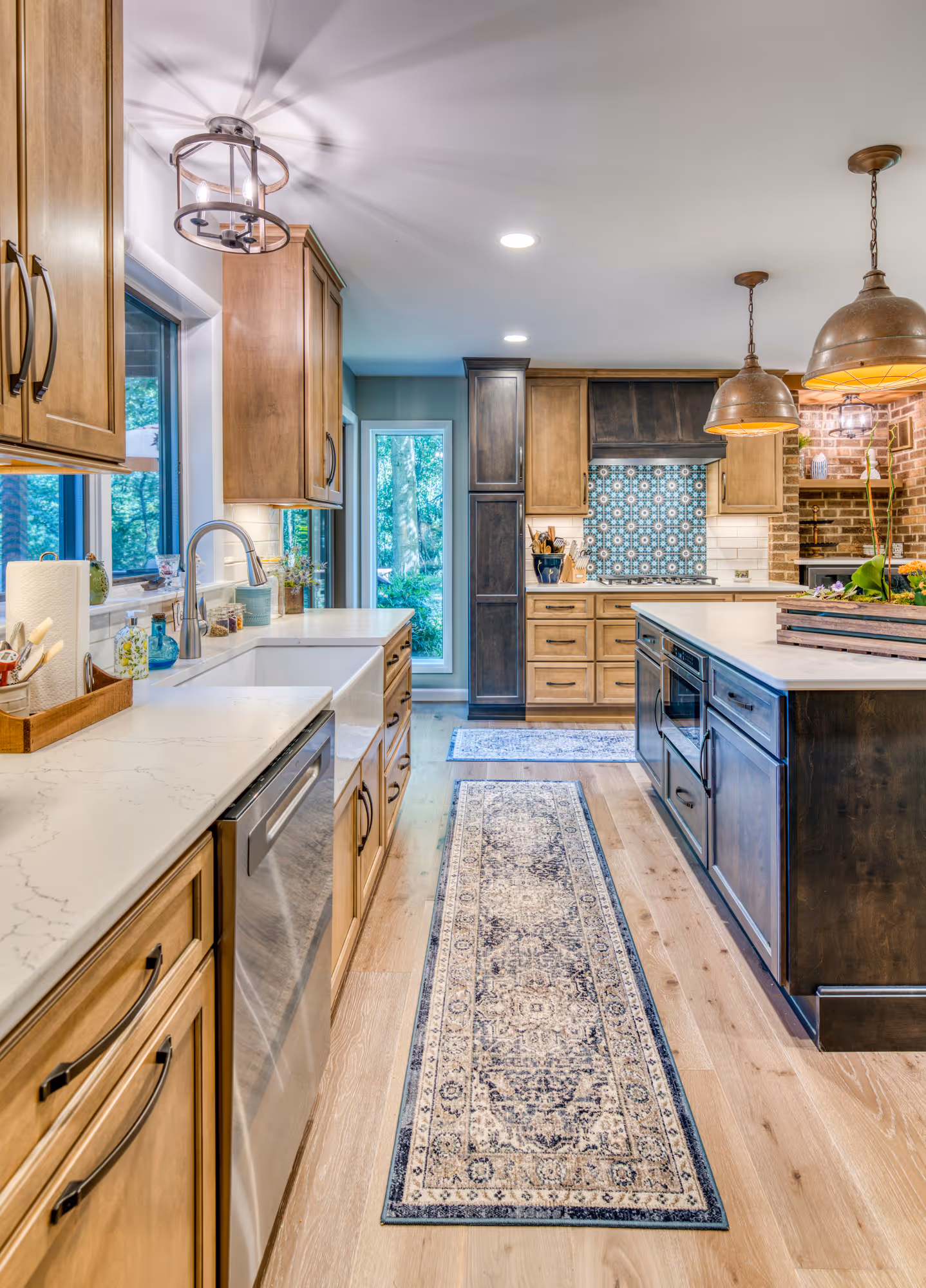 Stunning modern kitchen in Harrisburg, PA featuring wood cabinets, quartz countertops, and a decorative blue backsplash.