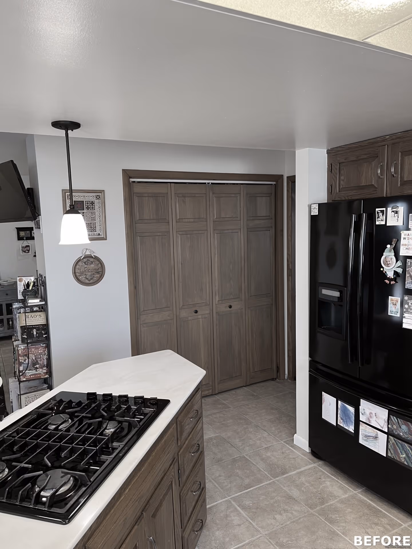 Modern kitchen in Harrisburg, PA featuring dark wood cabinetry, a gas cooktop, and a black refrigerator.