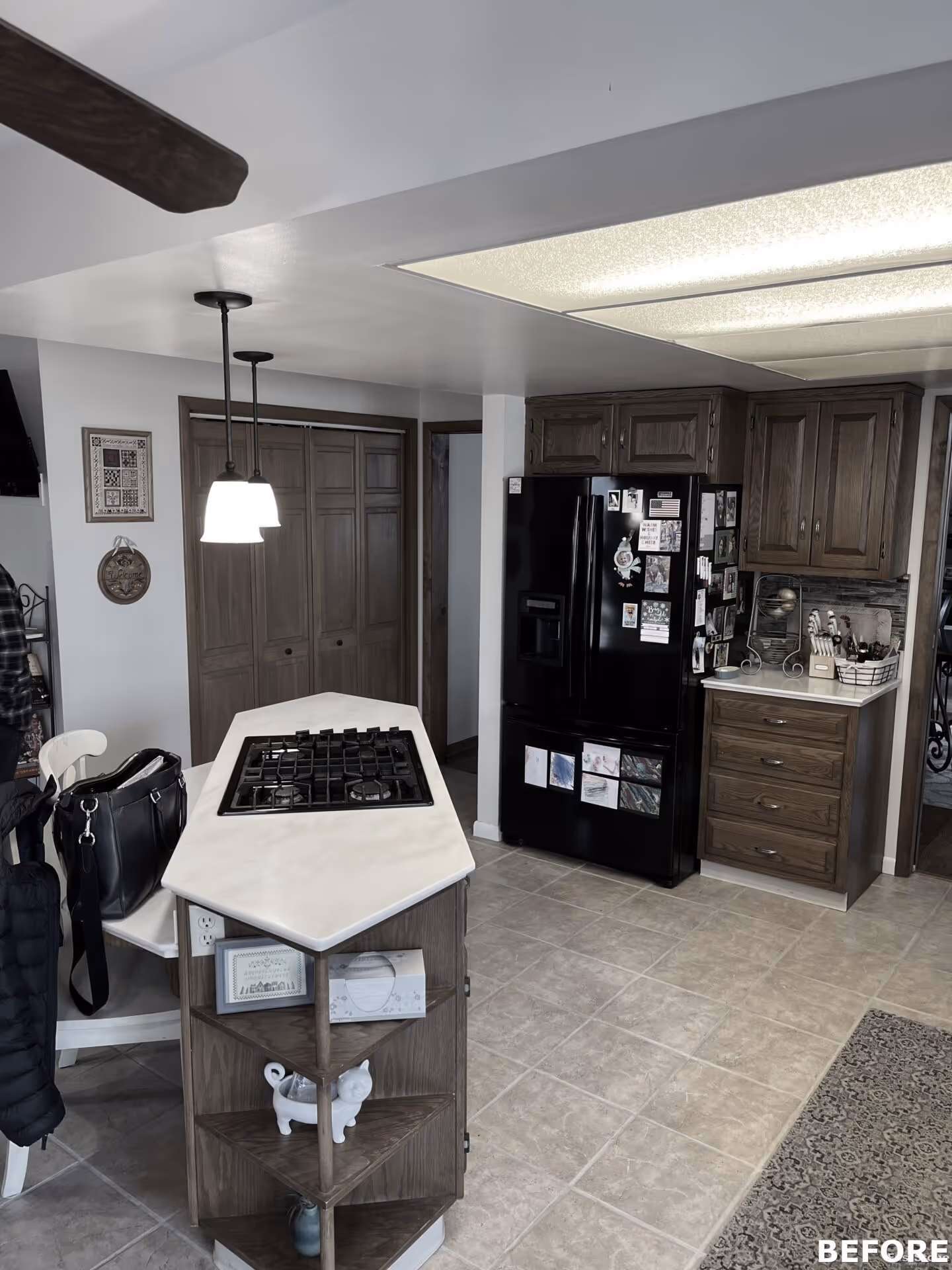 Modern kitchen in Harrisburg, PA with a white countertop, wooden cabinets, and gas cooktop.