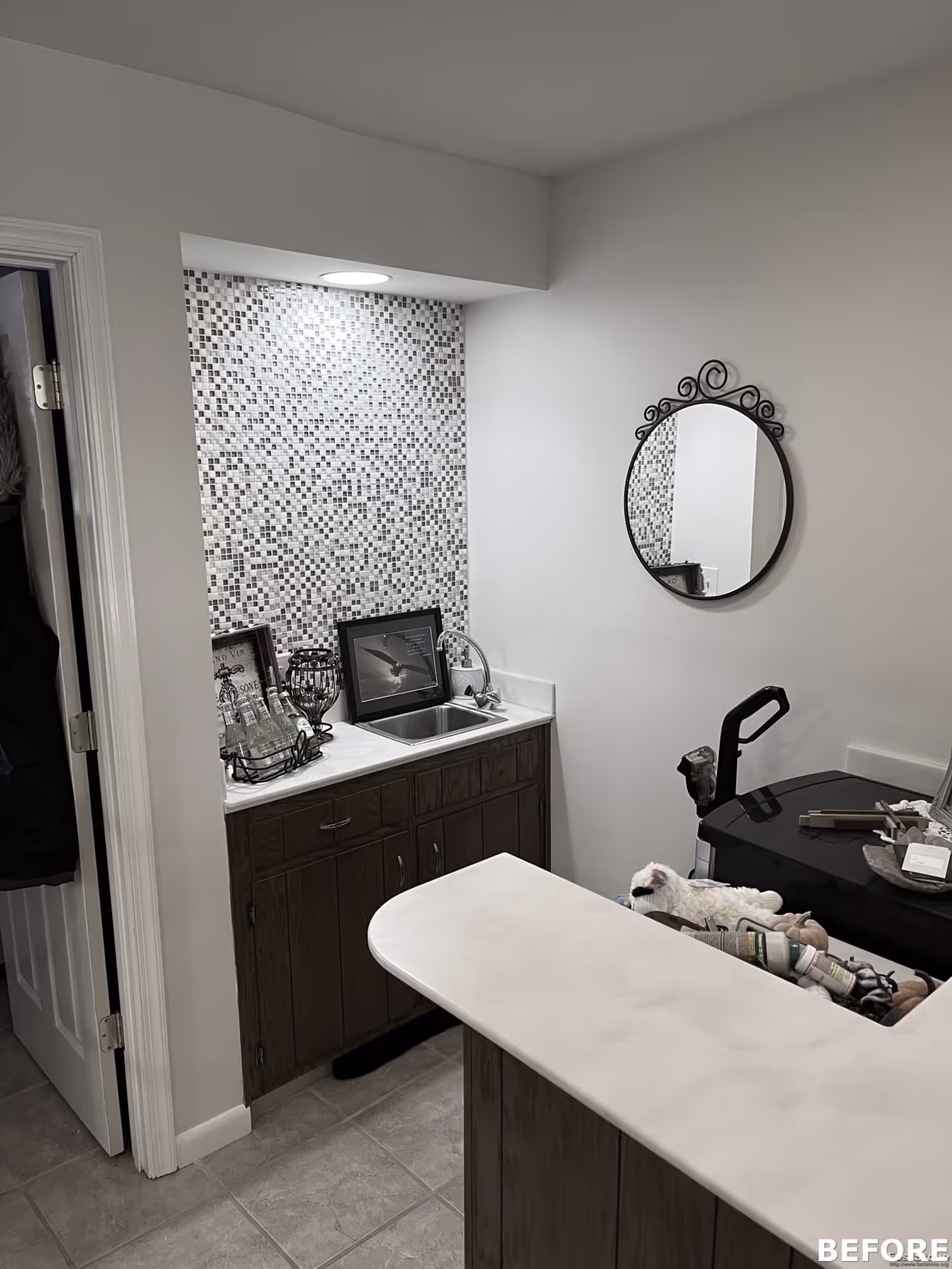 Small transitional bathroom in Harrisburg, PA, featuring black and white mosaic tiles, and a round mirror.