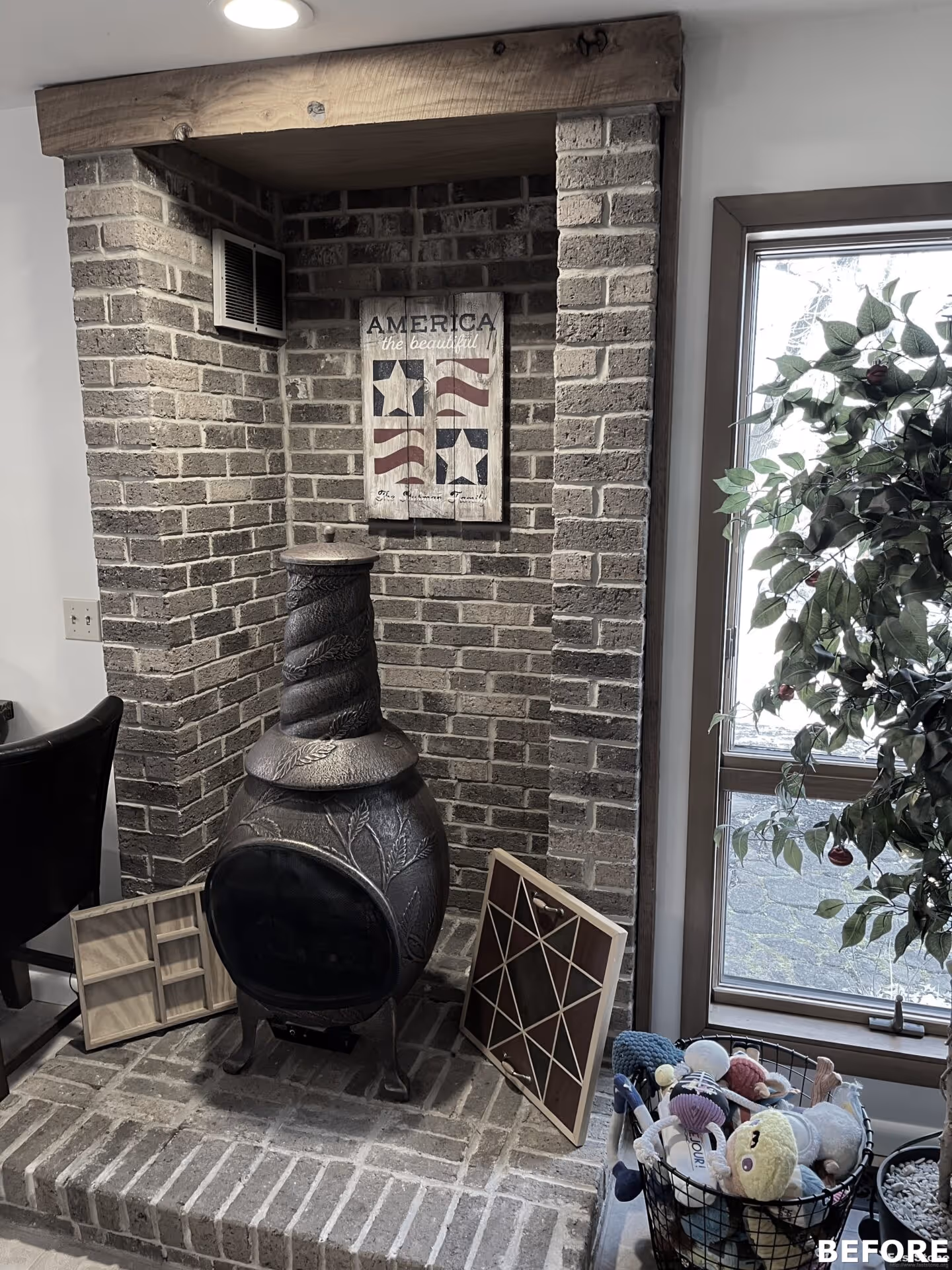 Cozy living room corner with a decorative brick fireplace and rustic Americana art in Harrisburg, PA